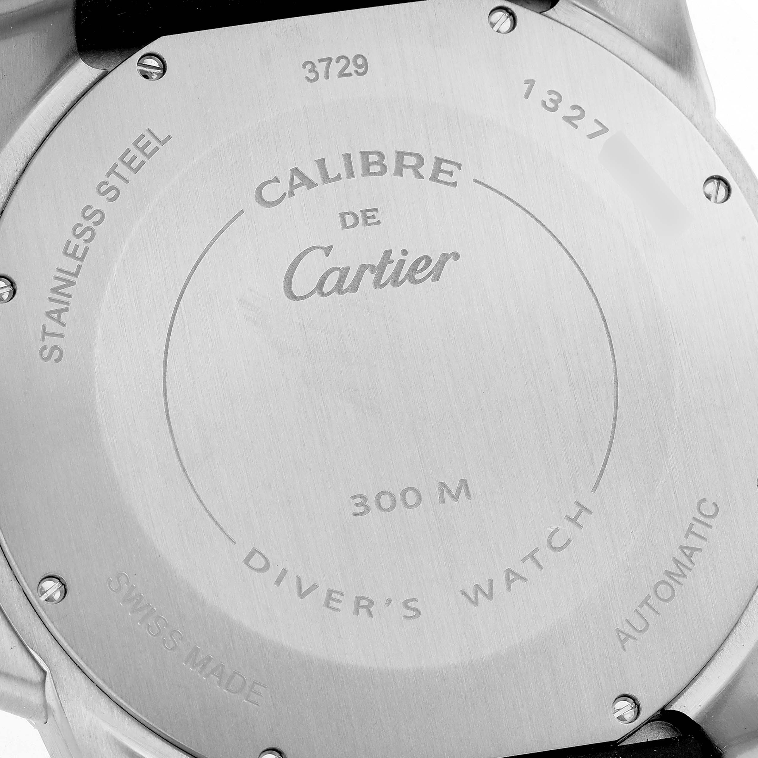 The image shows the back side of the Calibre de Cartier model watch by Cartier, highlighting engraving details and specifications.