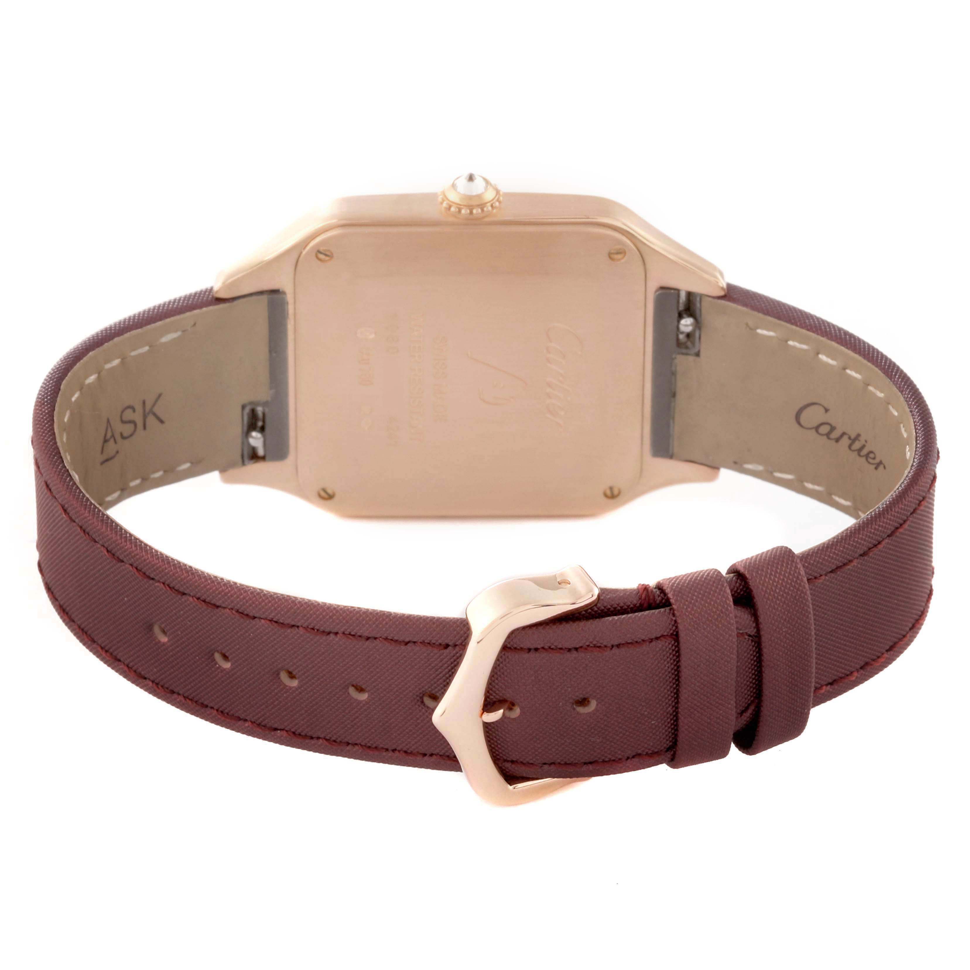 The image shows the back view of the Cartier Santos Dumont WJSA0018 Men's Rose Gold Silver Dial watch, focusing on the case back and brown strap with buckle.