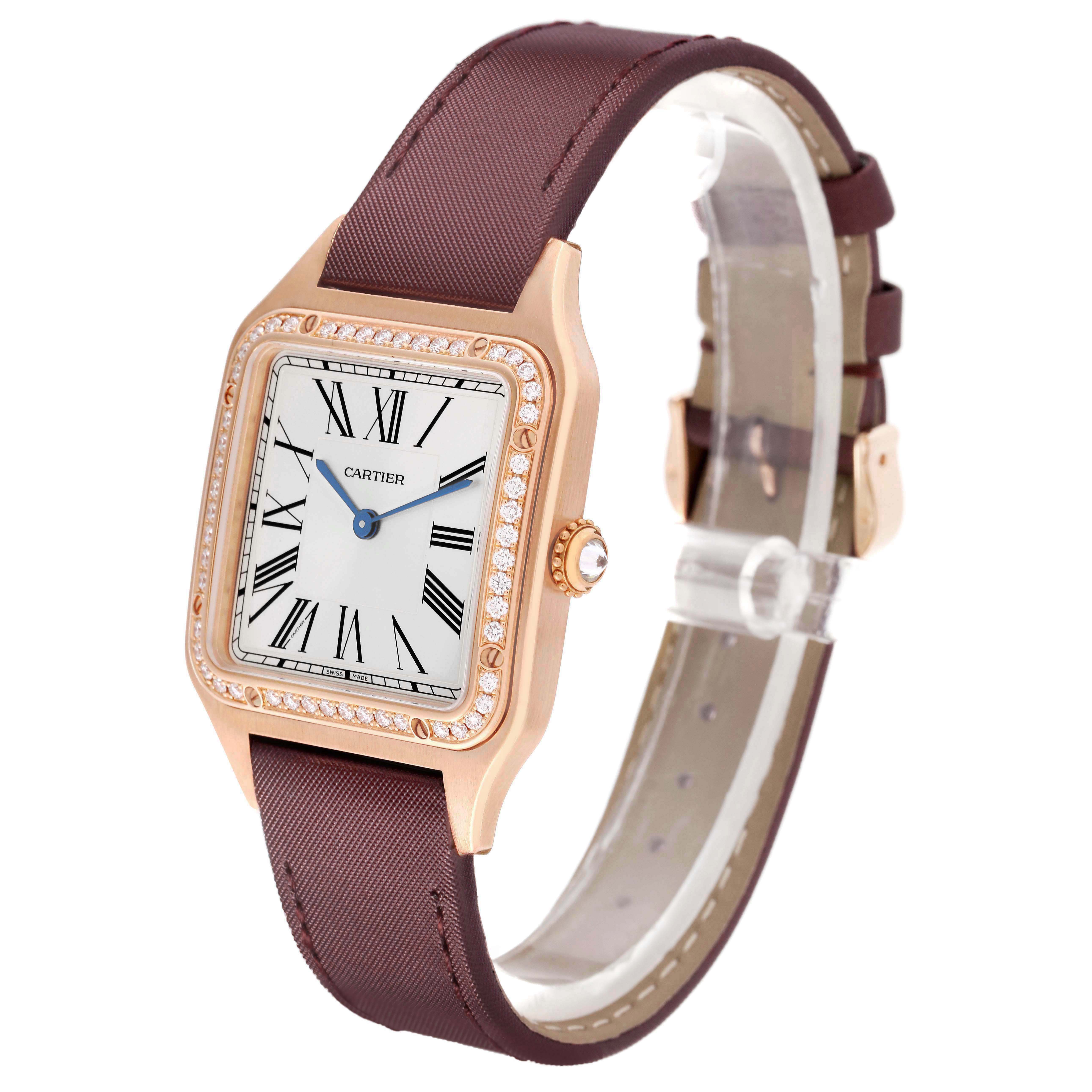 The Cartier Santos Dumont WJSA0018 Men's Rose Gold Silver Dial watch is shown at a three-quarter angle, highlighting the face, bezel, and brown strap.