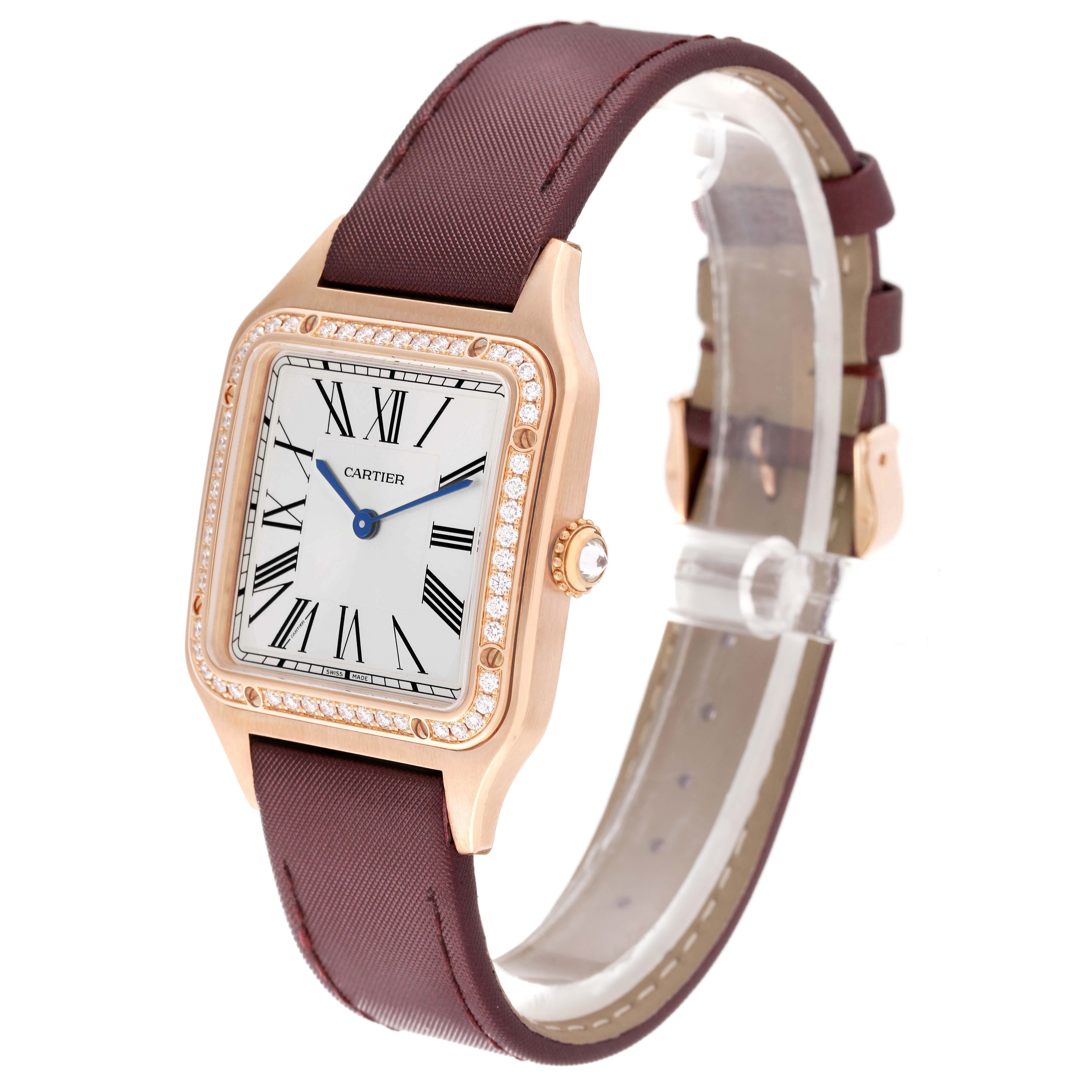 The Cartier Santos Dumont WJSA0018 Men's Rose Gold Silver Dial watch is shown from a front-left angle, highlighting the dial, bejeweled bezel, and strap.