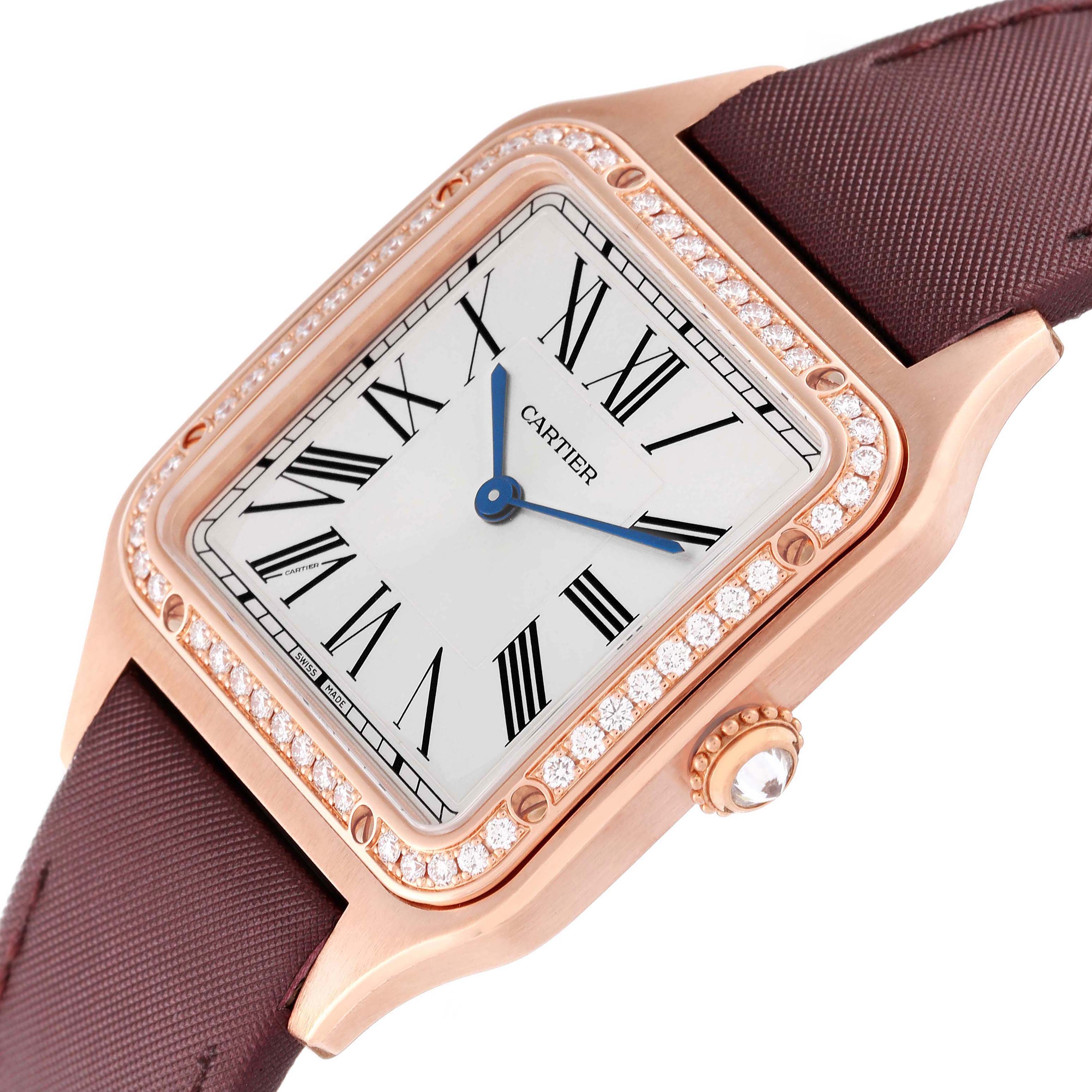 The Santos Dumont watch by Cartier is shown from an angled close-up, highlighting the face, bezel, and strap.