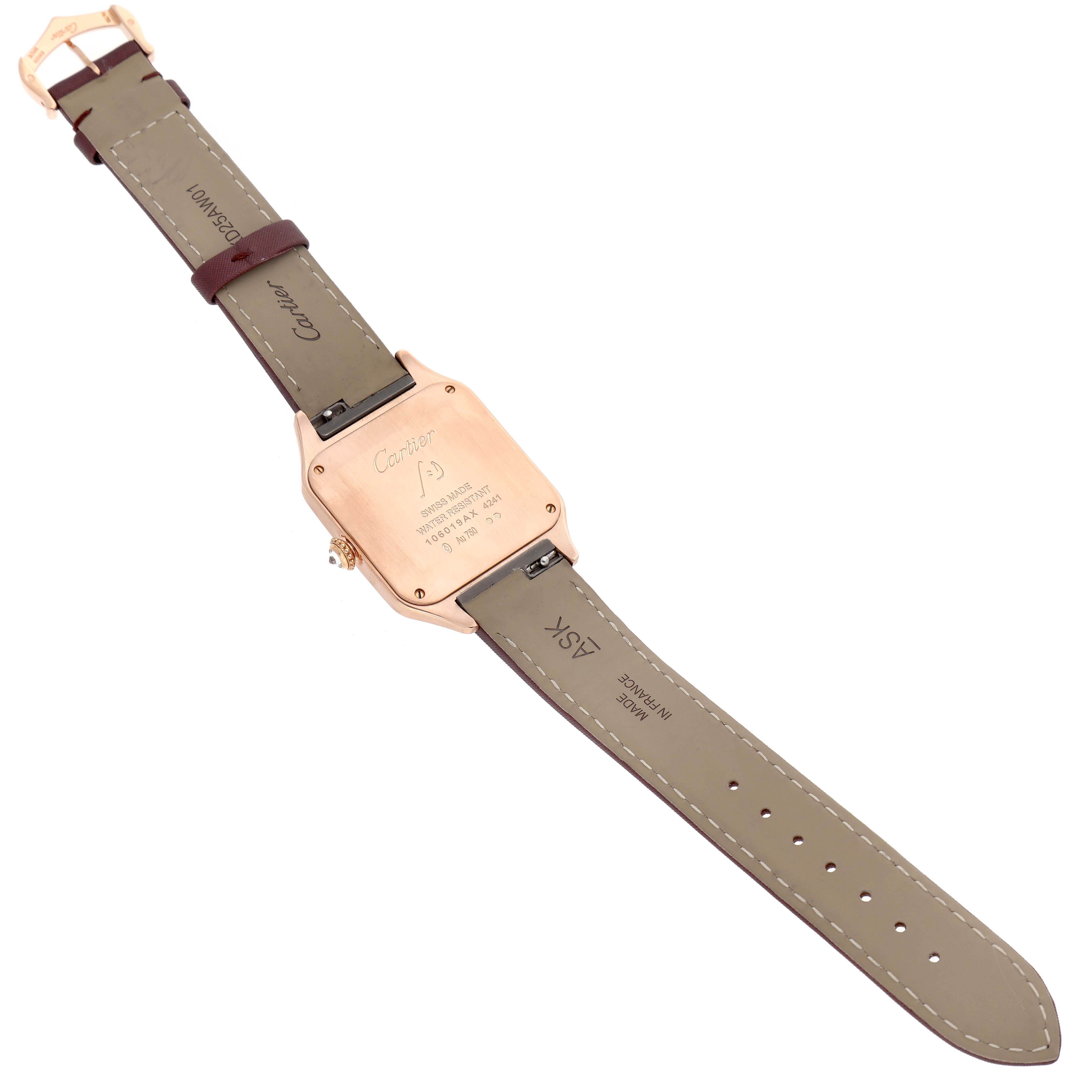 The image shows the back and strap of a Santos Dumont model by Cartier, lying flat with the case back's inscriptions visible.