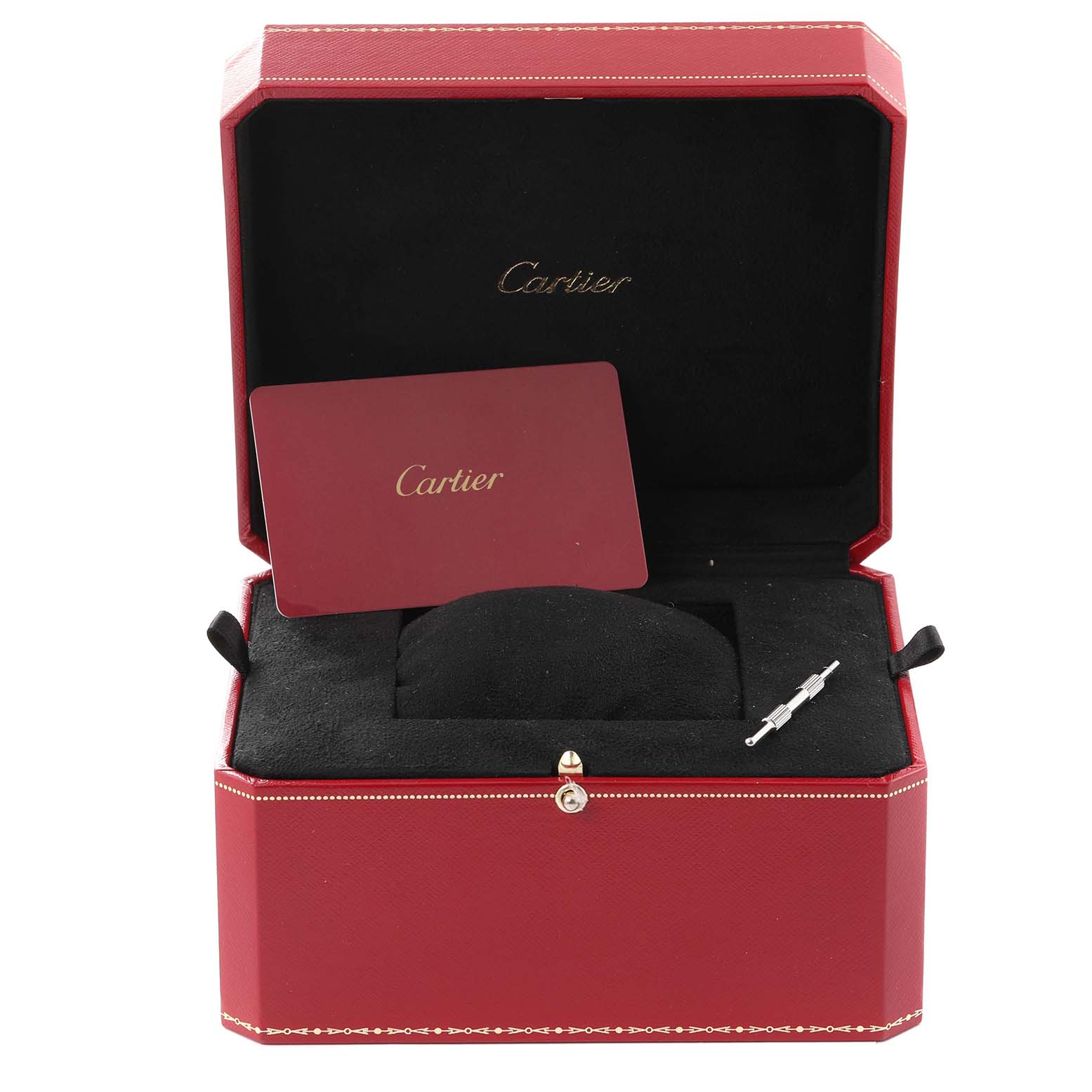 This image shows the open box of a Cartier Santos WSSA0009 Men
s Stainless Steel Silver Dial WSSA0009 Men
s Stainless Steel Silver Dial watch including a card and what appears to be a tool for adjusting the watch.