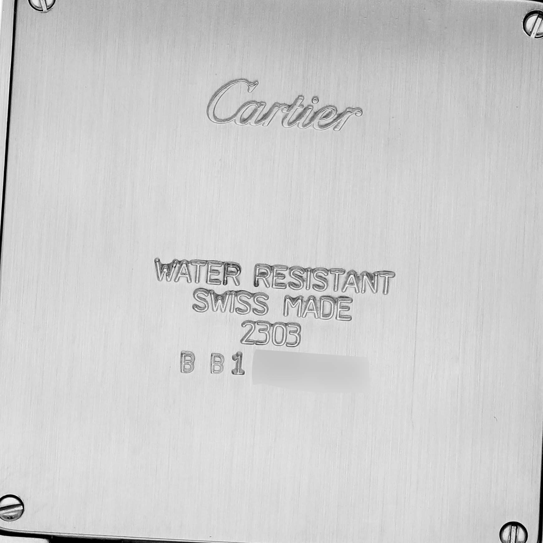 This image shows the back case of a Cartier Tank Francaise W51004Q4 Men
s Steel and Gold (two tone) Silver Dial W51004Q4 Men
s Steel and Gold (two tone) Silver Dial watch with engravings and screws visible.
