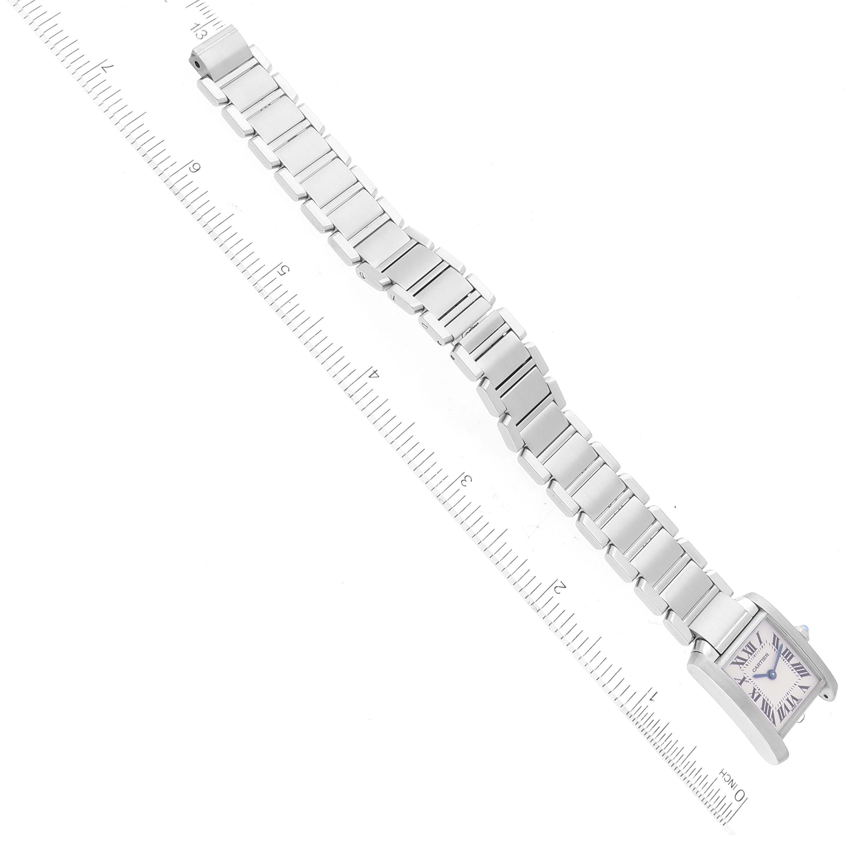 The image shows a top view of the Cartier Tank Francaise W51008Q3 Women
s Stainless Steel Silver Dial W51008Q3 Women
s Stainless Steel Silver Dial watch with its silver bracelet fully extended alongside a ruler for scale.