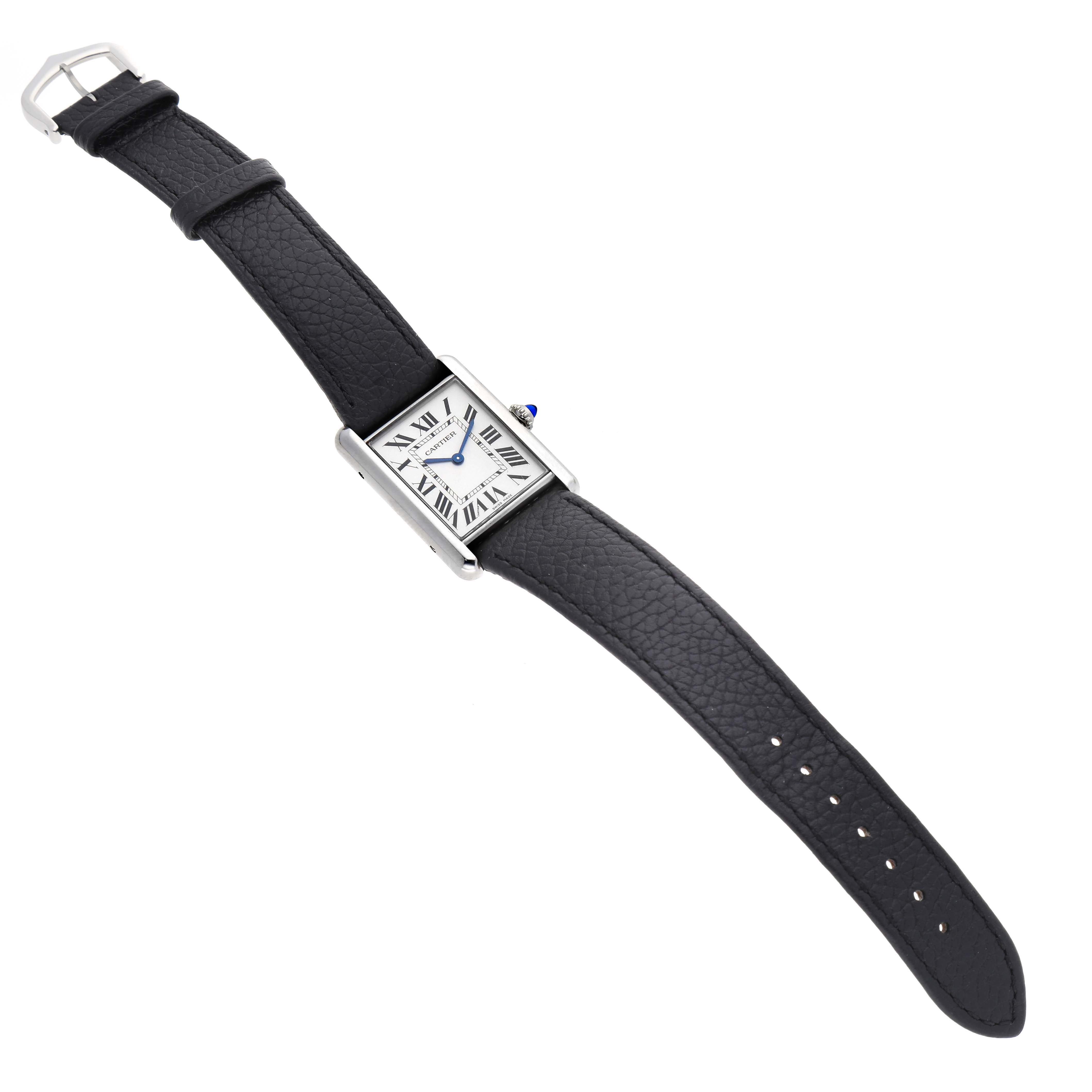 The Cartier Tank Must WSTA0120 Men's Stainless Steel Silver Dial watch is shown at an angled top view, displaying the face, case, strap, and buckle.