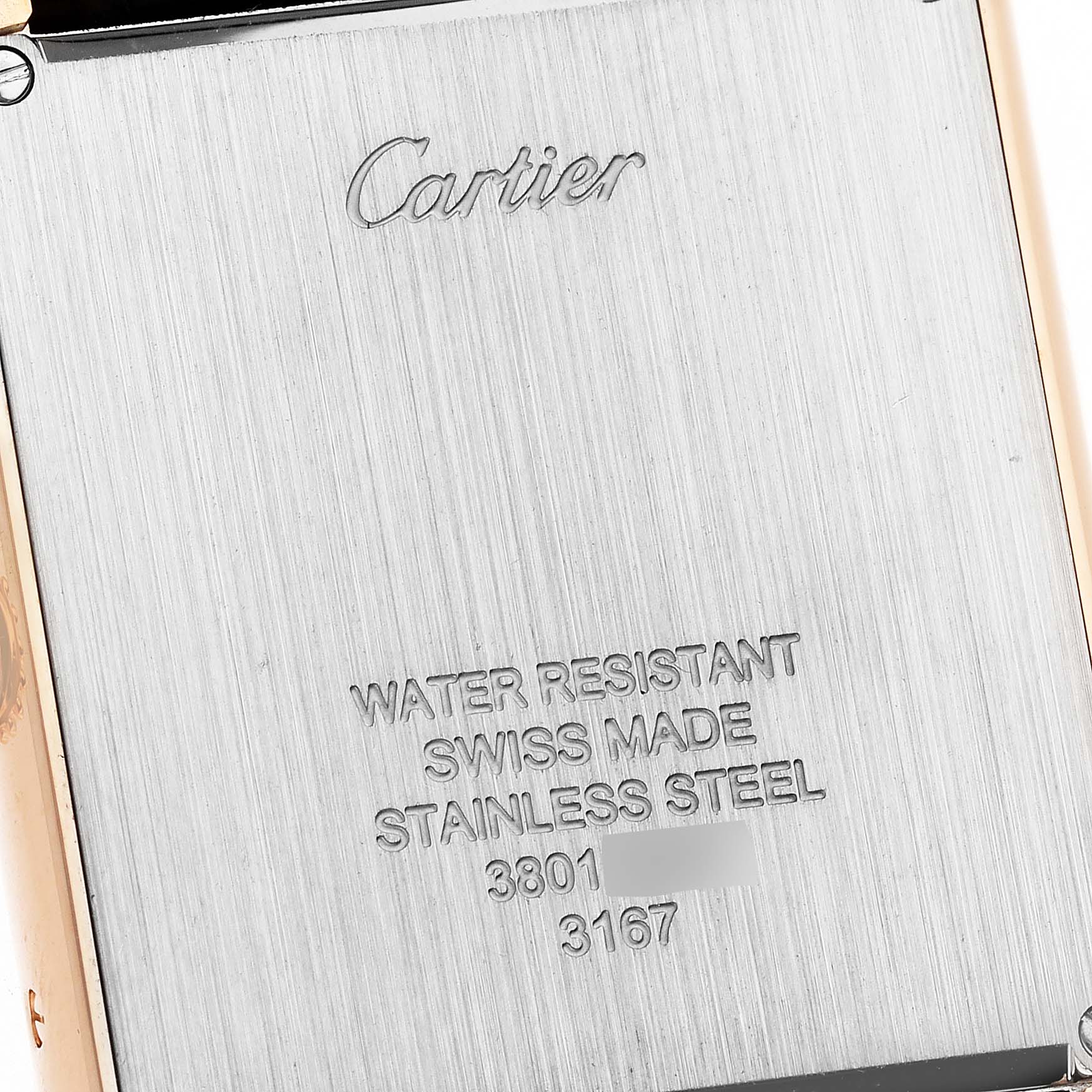 This image shows the engraved back case of a Cartier Tank Solo W5200025 Men's Steel and Gold (two tone) Silver Dial W5200025 Men's Steel and Gold (two tone) Silver Dial watch, highlighting its water resistance, material, and serial numbers.