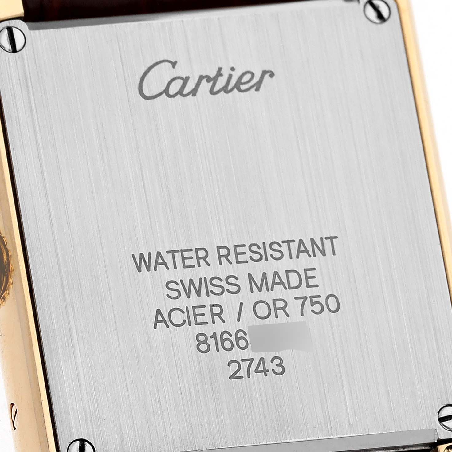 The image shows the back plate of a Cartier Tank Solo W1018755 Women's Steel and Gold (two tone) Silver Dial W1018755 Women's Steel and Gold (two tone) Silver Dial watch, displaying brand engraving and specifications.