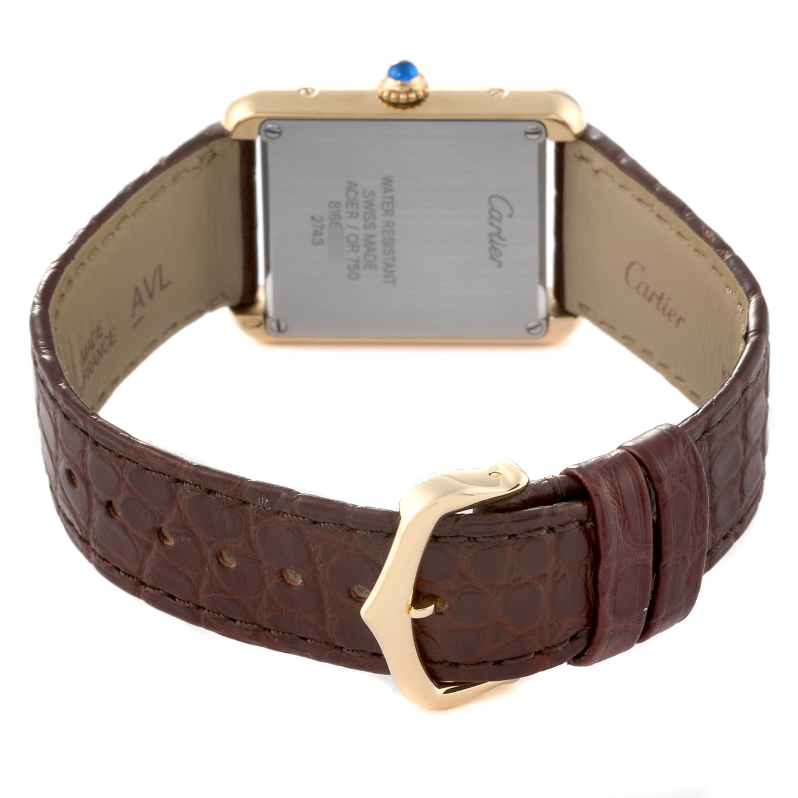 The image shows the back view of the Cartier Tank Solo W1018755 Women's Steel and Gold (two tone) Silver Dial W1018755 Women's Steel and Gold (two tone) Silver Dial watch, highlighting the case back, crown, and brown leather strap.