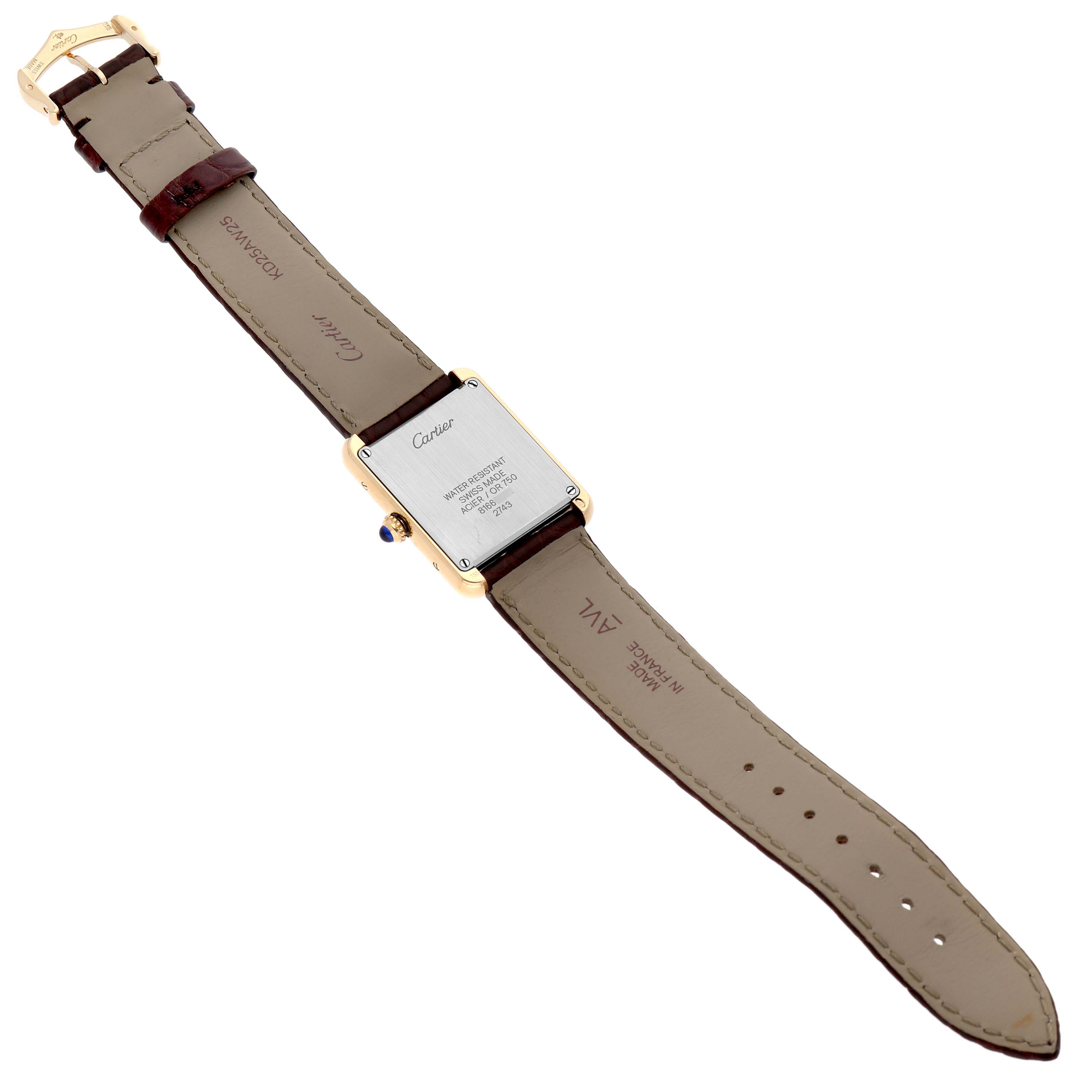 The Cartier Tank Solo W1018755 Women's Steel and Gold (two tone) Silver Dial W1018755 Women's Steel and Gold (two tone) Silver Dial watch is shown from the back, displaying the caseback, crown, and leather strap.