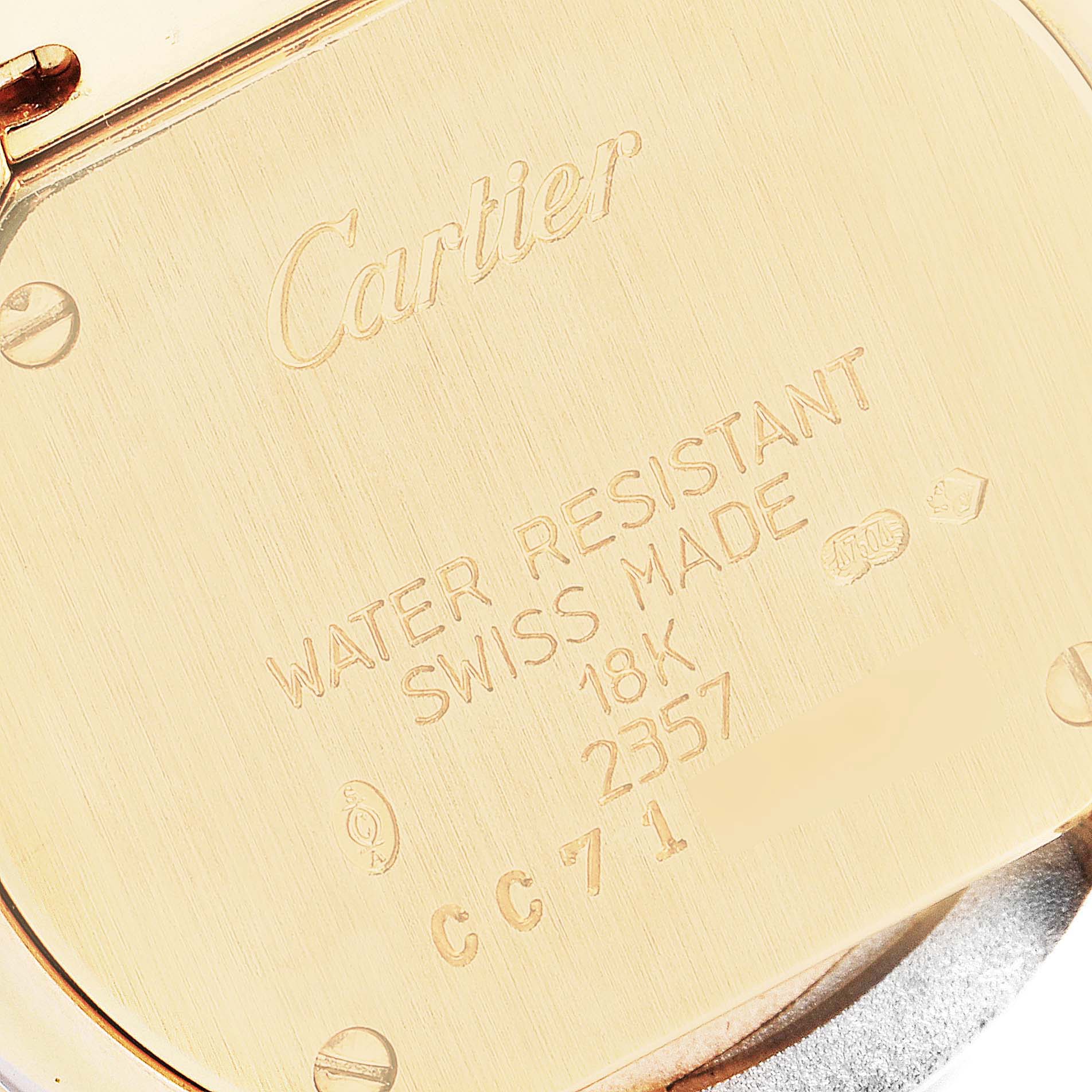 The image shows the back of a Cartier Trinity 2357 Women's Yellow Gold Beige Dial 2357 Women's Yellow Gold Beige Dial watch, highlighting its engravings including "Cartier," "Water Resistant," and "18K."
