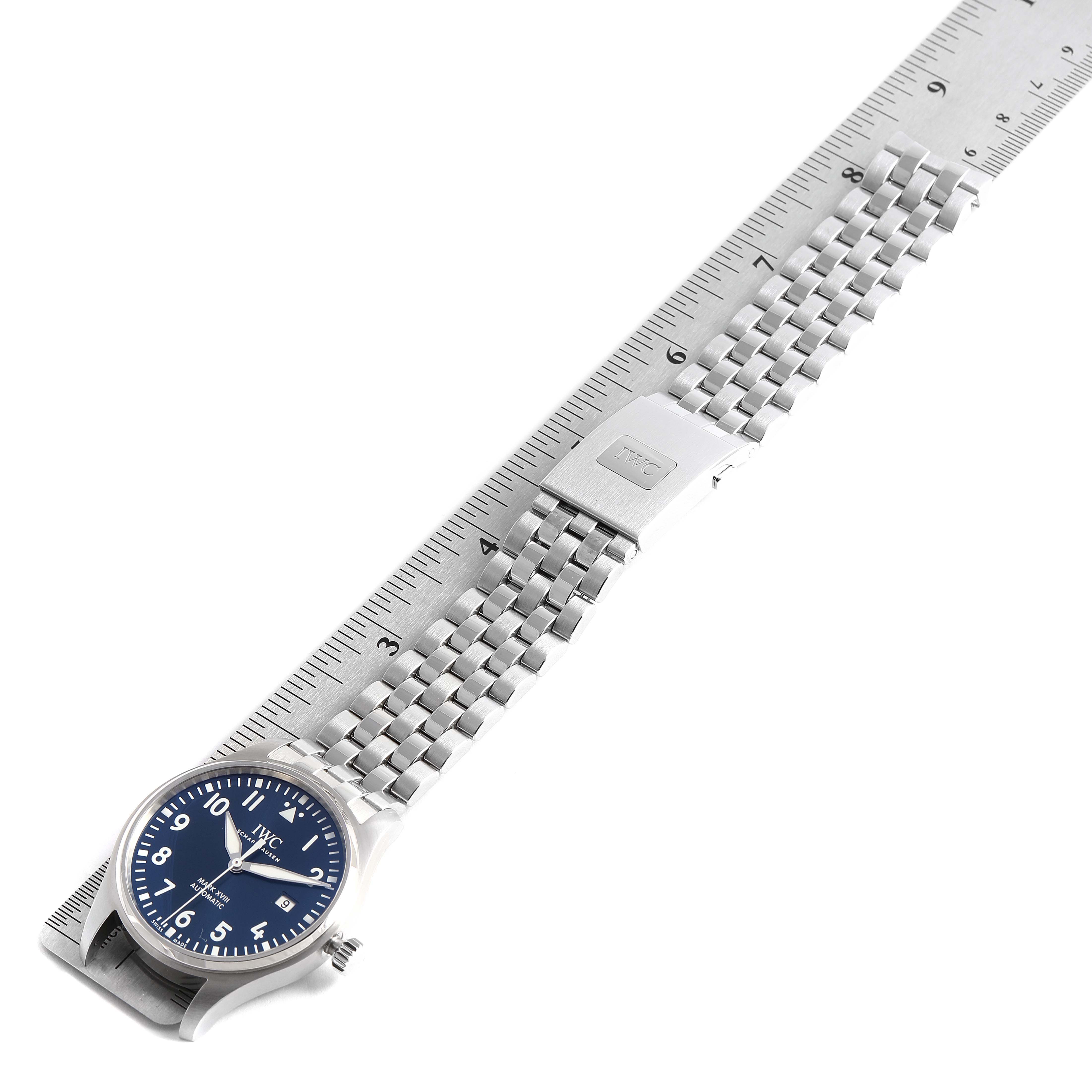 The image shows an IWC Pilot 29275 Men's Stainless Steel Blue Dial 29275 Men's Stainless Steel Blue Dial watch with a metal bracelet and clasp, positioned alongside a ruler for scale.