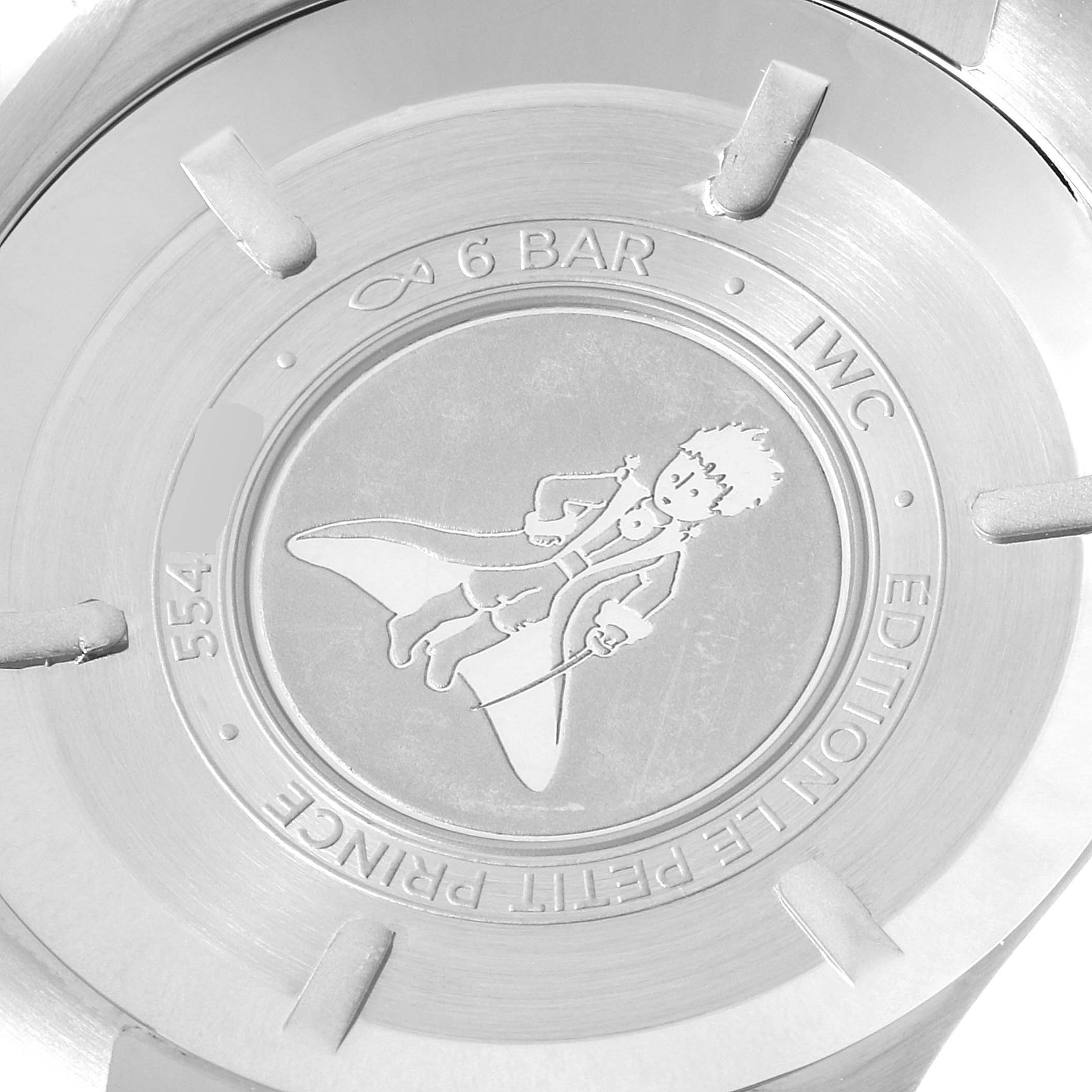 The image shows the back case of an IWC Pilot 29275 Men's Stainless Steel Blue Dial 29275 Men's Stainless Steel Blue Dial model watch, featuring an engraved "Le Petit Prince" design and text.