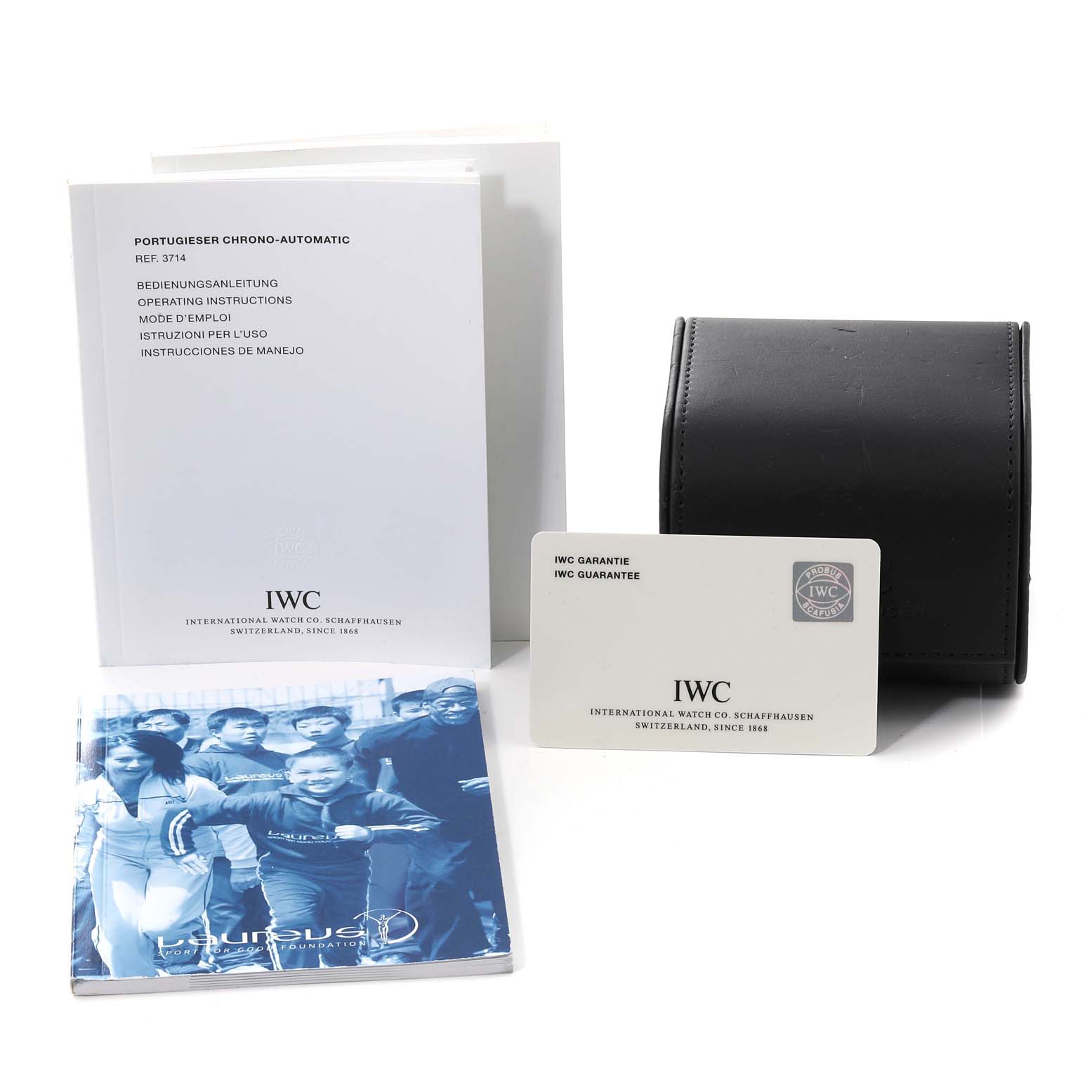 This image shows the accessories for the IWC Portuguese IW371432 Men's Stainless Steel Blue Dial IW371432 Men's Stainless Steel Blue Dial model, including the manual, warranty card, carrying case, and a brochure.