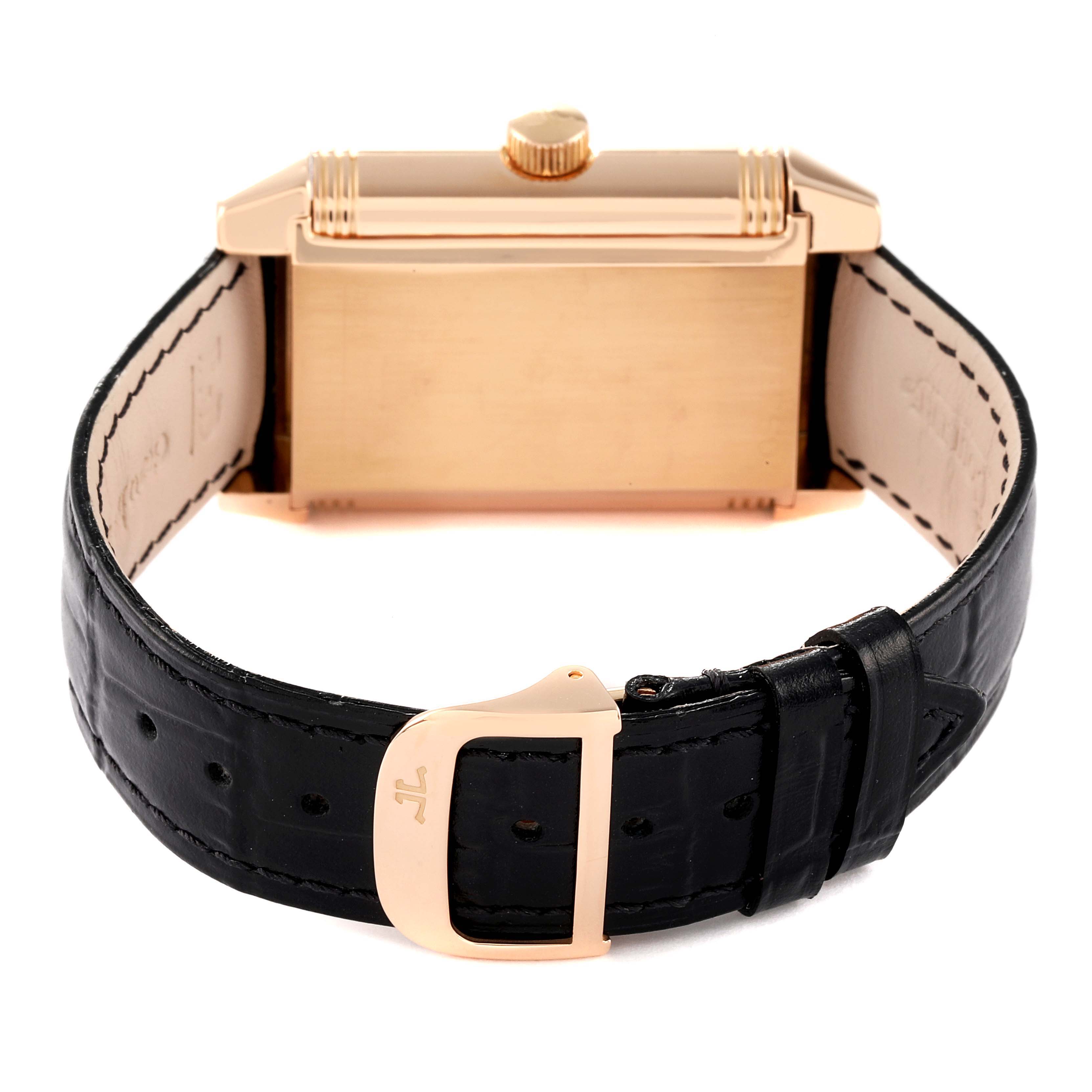 The image shows the backside of a Jaeger LeCoultre Reverso Q3012420 Men
s Rose Gold Silver Dial Q3012420 Men
s Rose Gold Silver Dial watch with its leather strap and clasp visible.