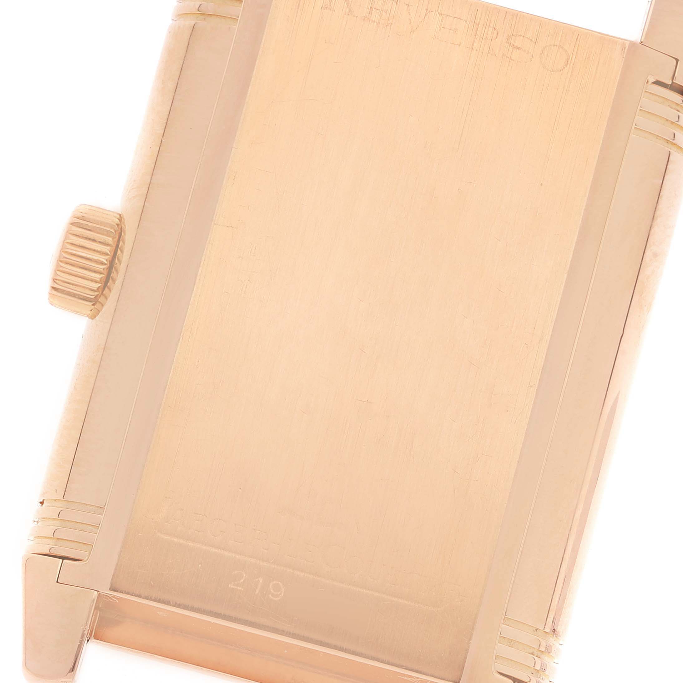 The image shows a close-up of the back of a Jaeger-LeCoultre Reverso watch, specifically highlighting the crown and engraved case back details.