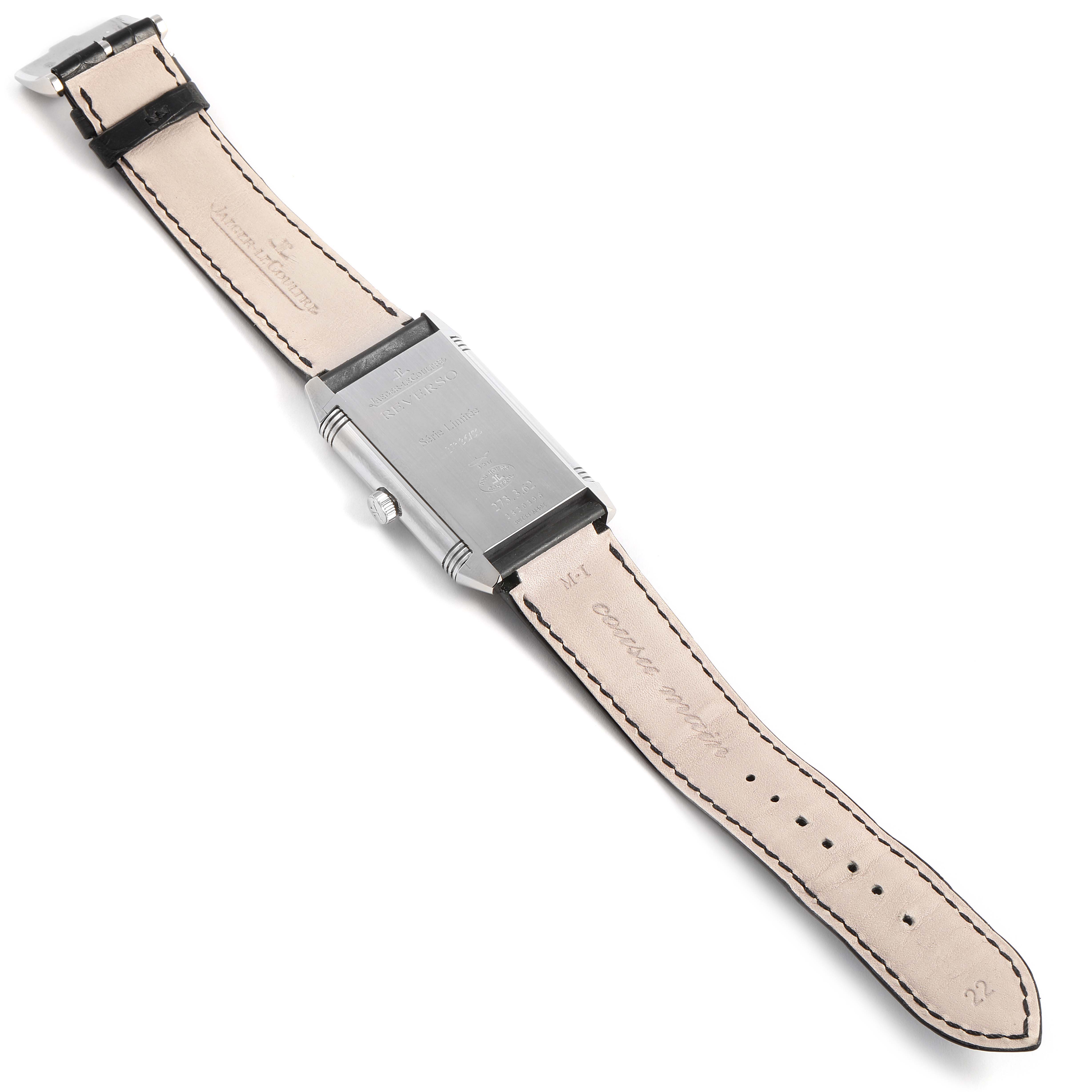 The image shows the back and leather strap of a Jaeger-LeCoultre Reverso watch, lying flat with the strap fully extended.