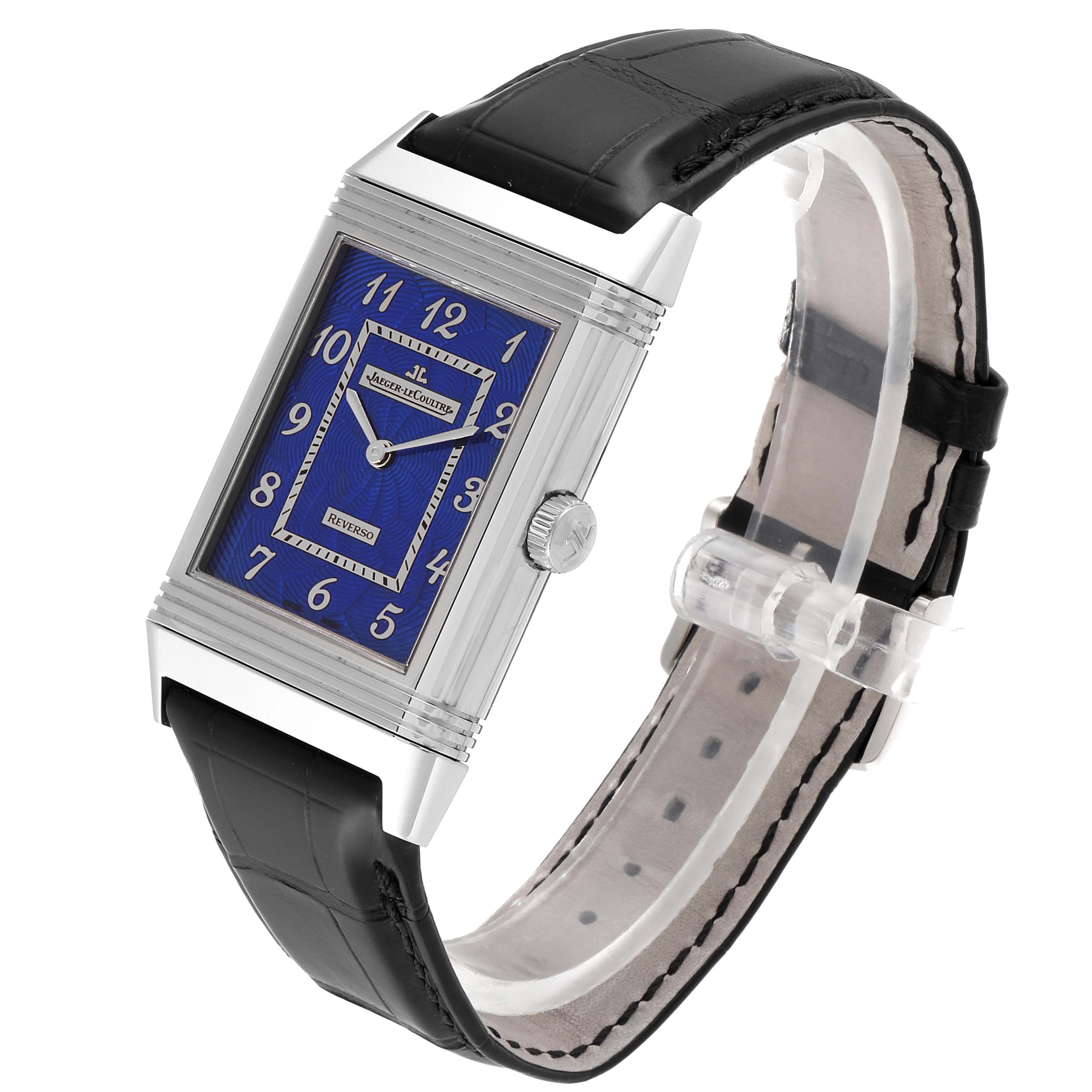 This Jaeger LeCoultre Reverso Q33735E1 Men's White Gold Blue Dial Q33735E1 Men's White Gold Blue Dial watch is shown at a slight angle, displaying the rectangular face, dial, crown, and leather strap.