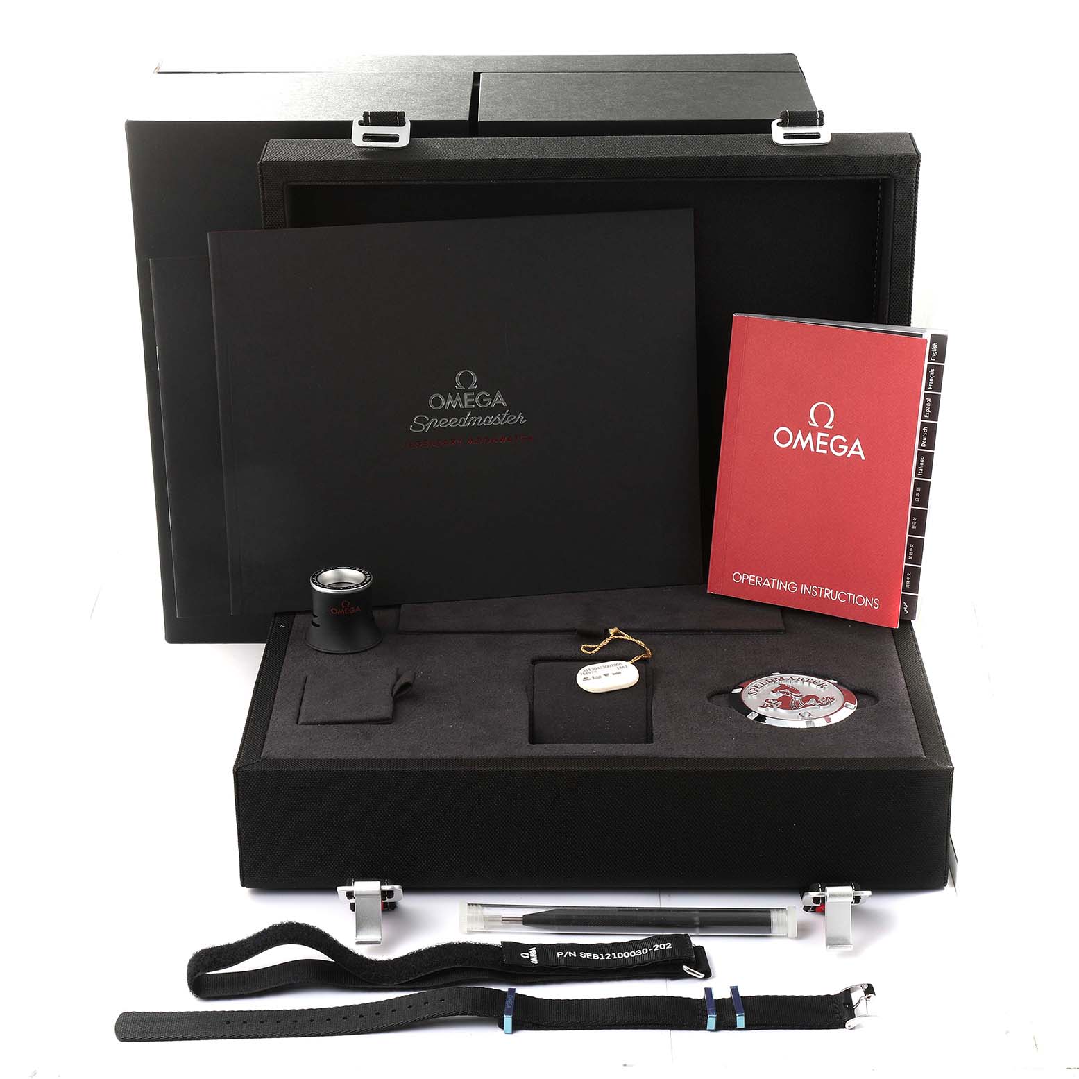 The image shows a complete set of Omega Speedmaster 311.30.42.30.01.005 Men
s Stainless Steel Black Dial 311.30.42.30.01.005 Men
s Stainless Steel Black Dial accessories, including manuals, straps, a loupe, and a presentation box, viewed from above.