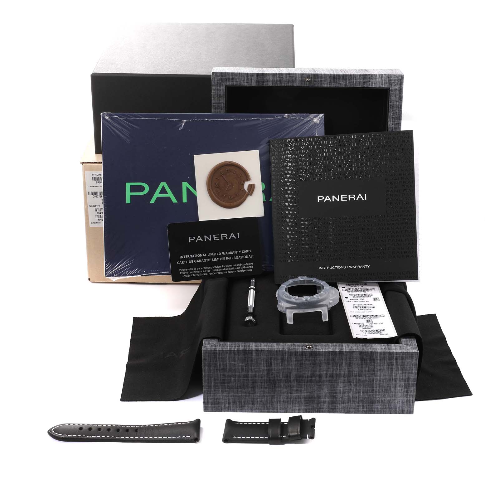 The package shows accessories for the Panerai Submersible PAM01039 Men's Ceramic Grey Dial PAM01039 Men's Ceramic Grey Dial model, including straps, warranty card, case, and manuals from an angled top-down view.