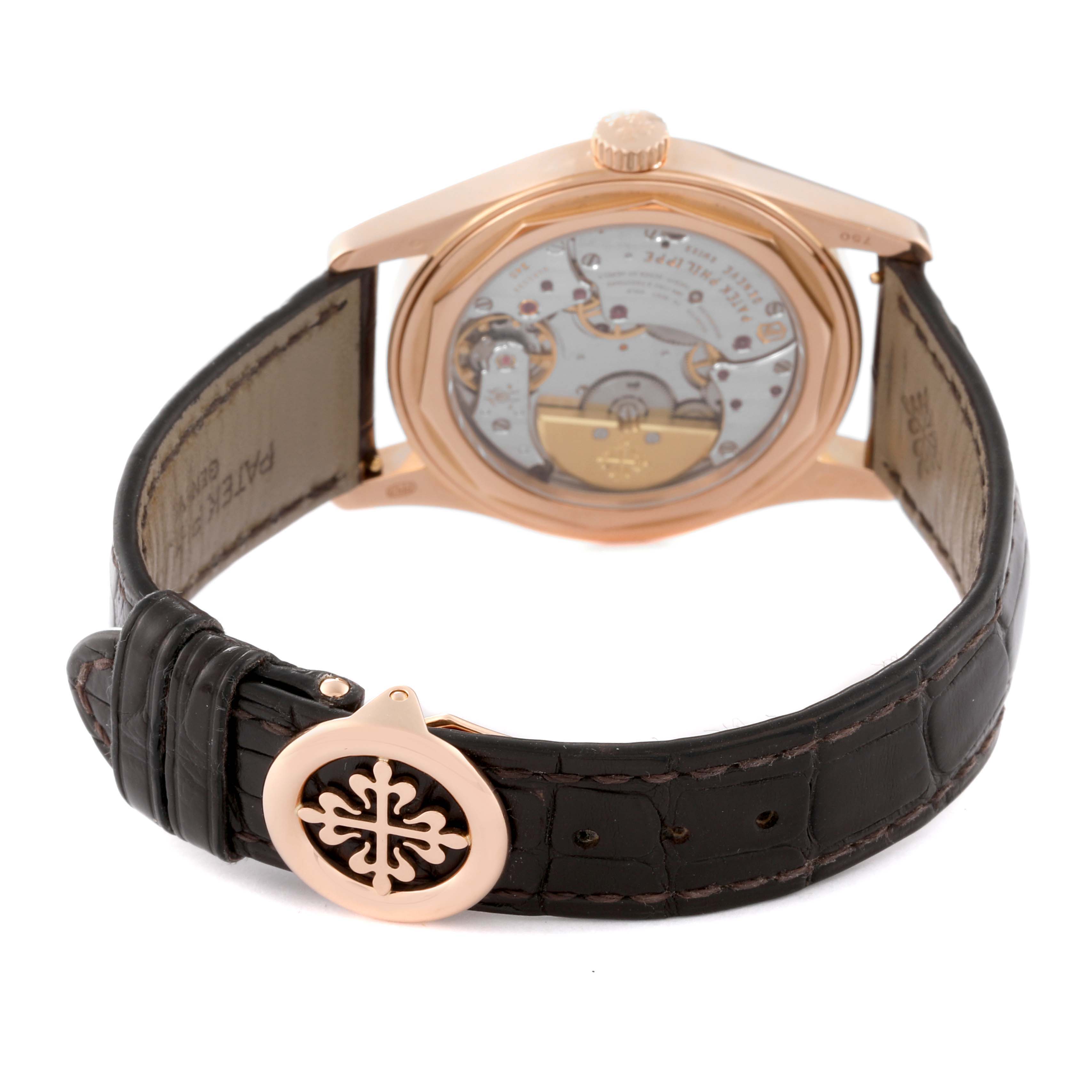 The image shows the back view of a Patek Philippe Calatrava 6000R-001 Men's Rose Gold Brown Dial 6000R-001 Men's Rose Gold Brown Dial watch, highlighting the open case back and leather strap with buckle.