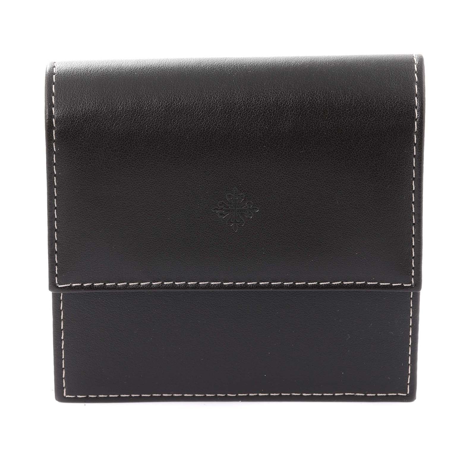 This image shows a black leather watch case for a Patek Philippe Calatrava 6000R-001 Men's Rose Gold Brown Dial 6000R-001 Men's Rose Gold Brown Dial model, featuring white stitching and the brand's emblem.