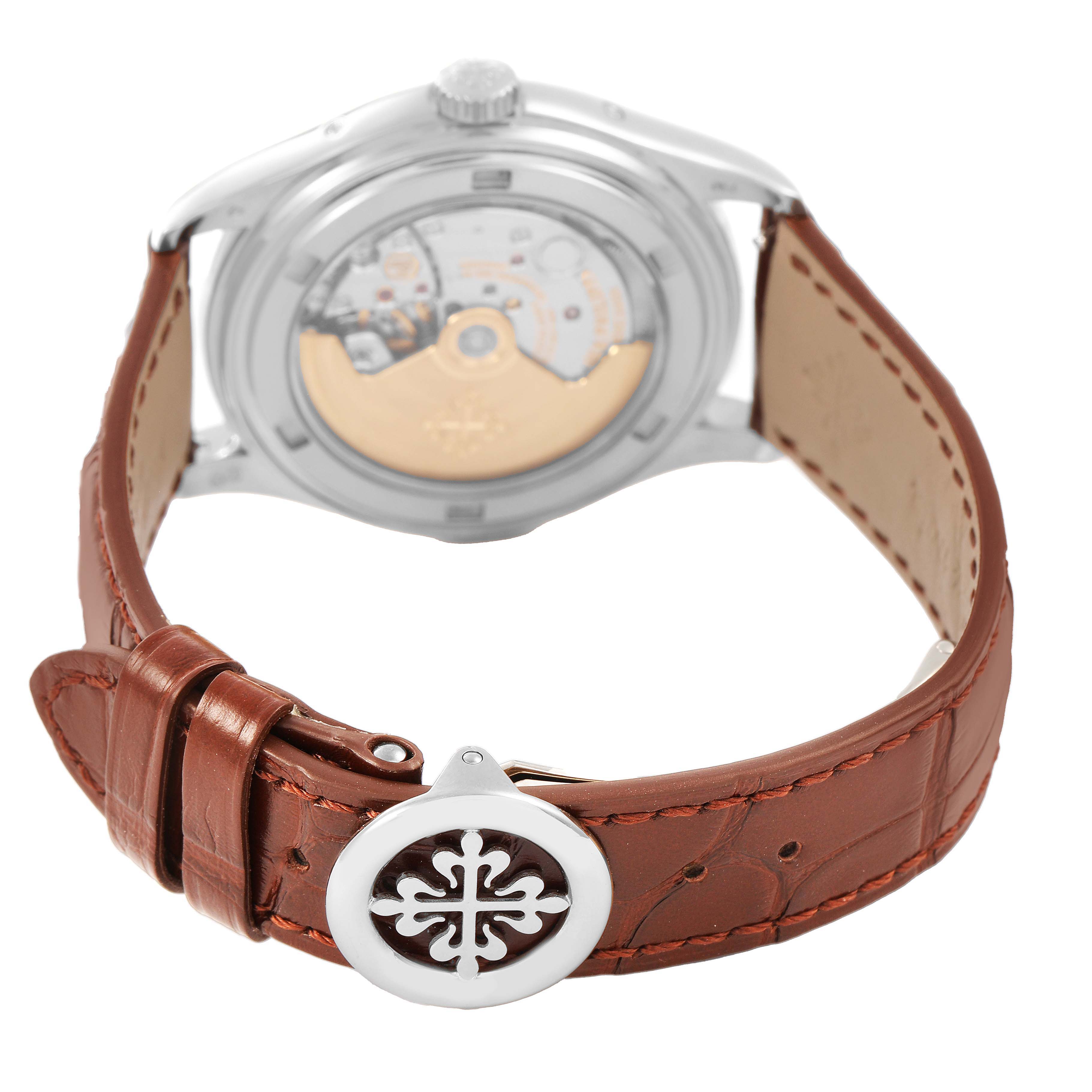 The image shows the back of the Patek Philippe Complications 5146G-001 Men's White Gold White Dial watch, highlighting its movement and brown leather strap.