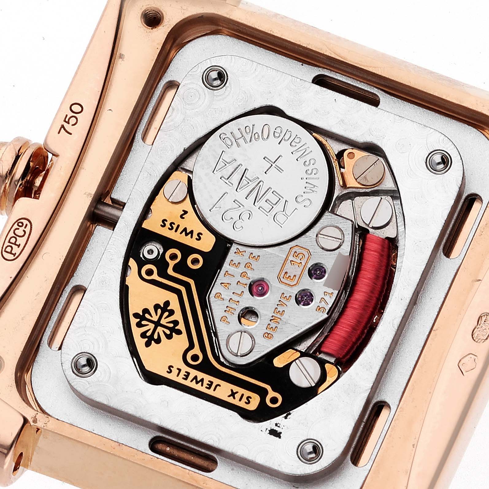 The image shows the back view of a Patek Philippe Twenty-4 4910/11R Women's Rose Gold Brown Dial 4910/11R Women's Rose Gold Brown Dial watch, highlighting its movement and battery compartment.