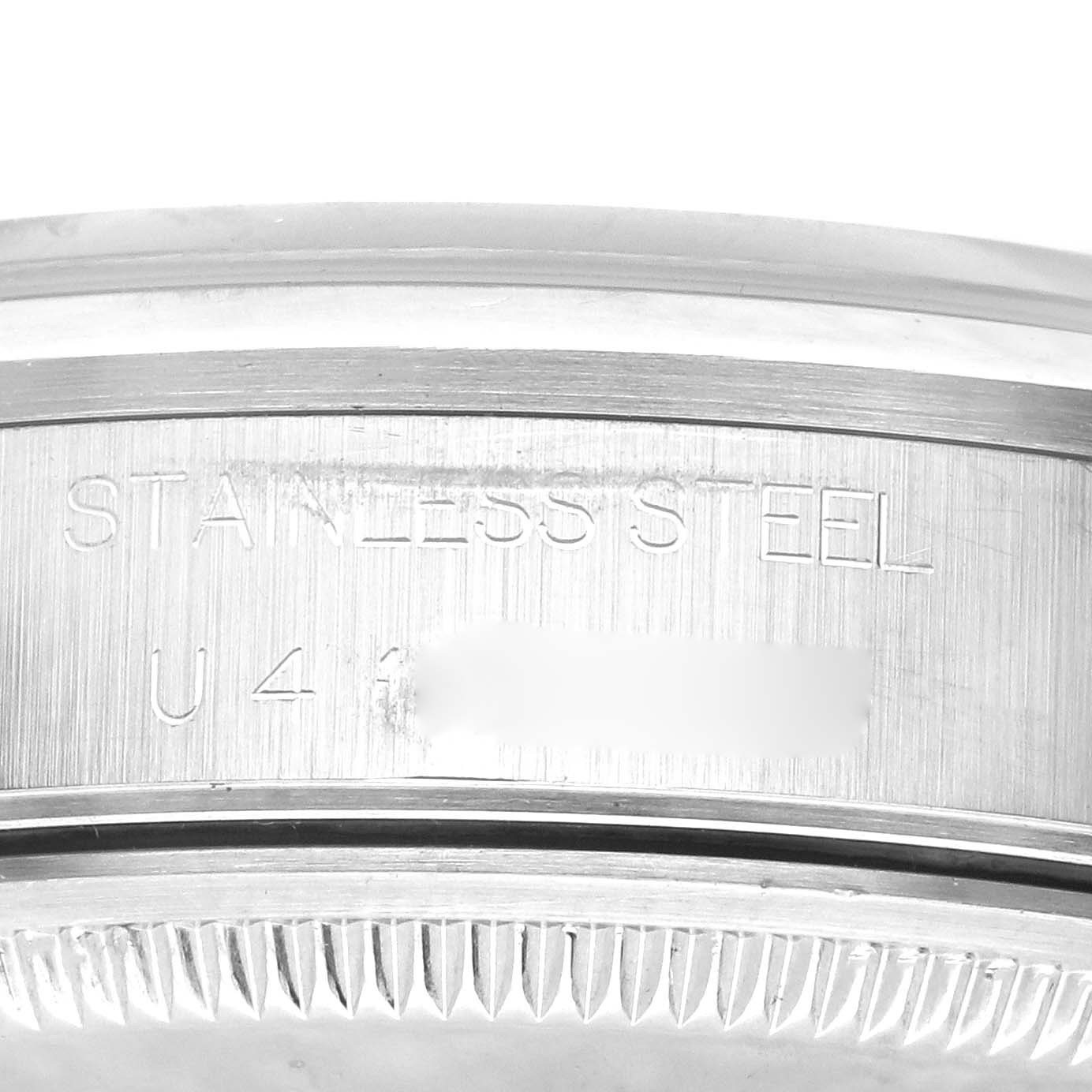 This image shows the side engraving and part of the bezel of a stainless steel Rolex Air-King 14000 Men's Stainless Steel Blue Dial 14000 Men's Stainless Steel Blue Dial watch.