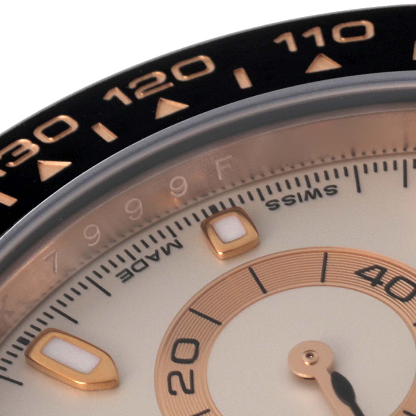 Close-up of a Rolex Daytona 116515LN Men
s Rose Gold White Dial 116515LN Men
s Rose Gold White Dial watch showing part of the dial, bezel with tachymeter, and hour markers.