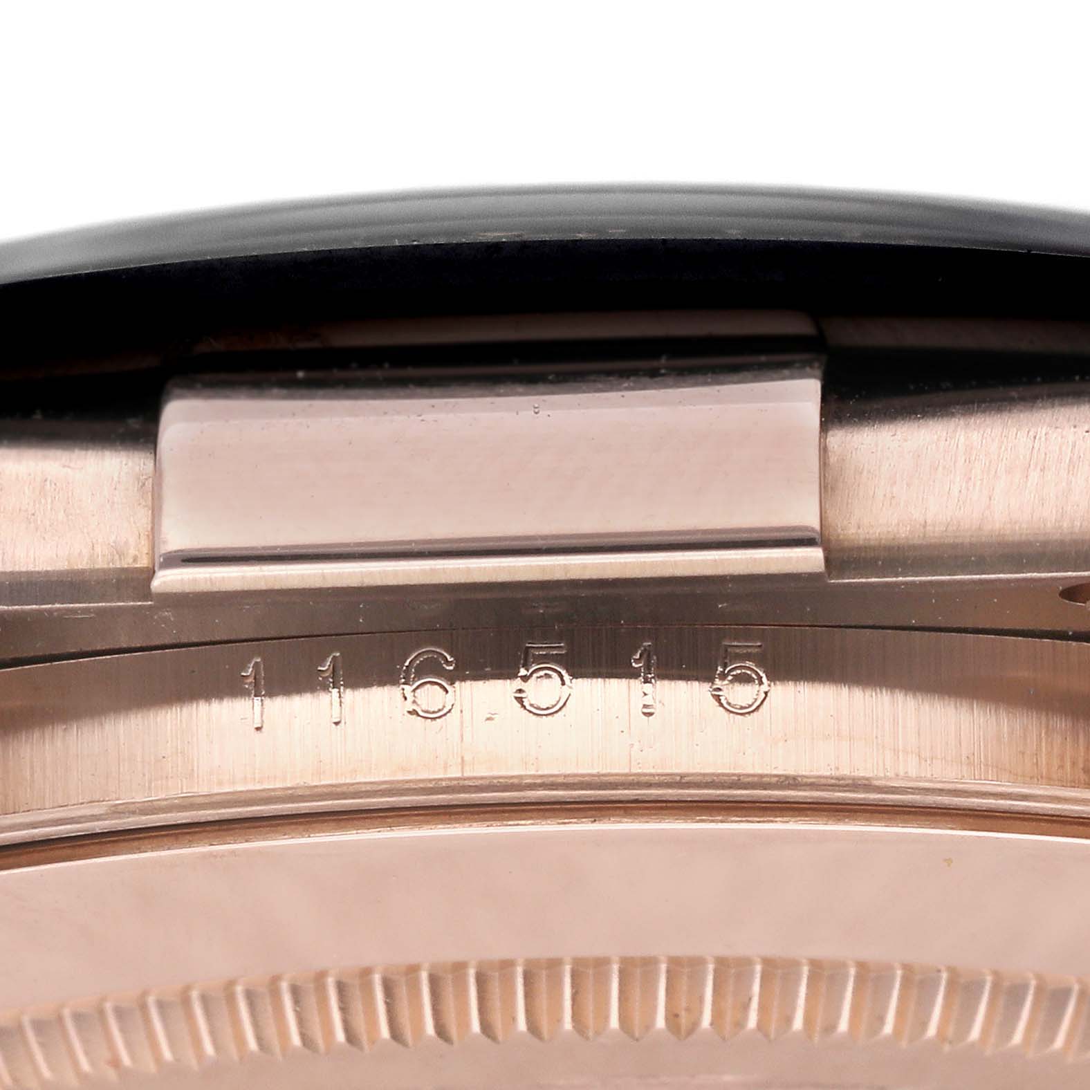 This close-up image shows the side detail and model number of the Rolex Daytona 116515LN Men
s Rose Gold White Dial 116515LN Men
s Rose Gold White Dial watch.
