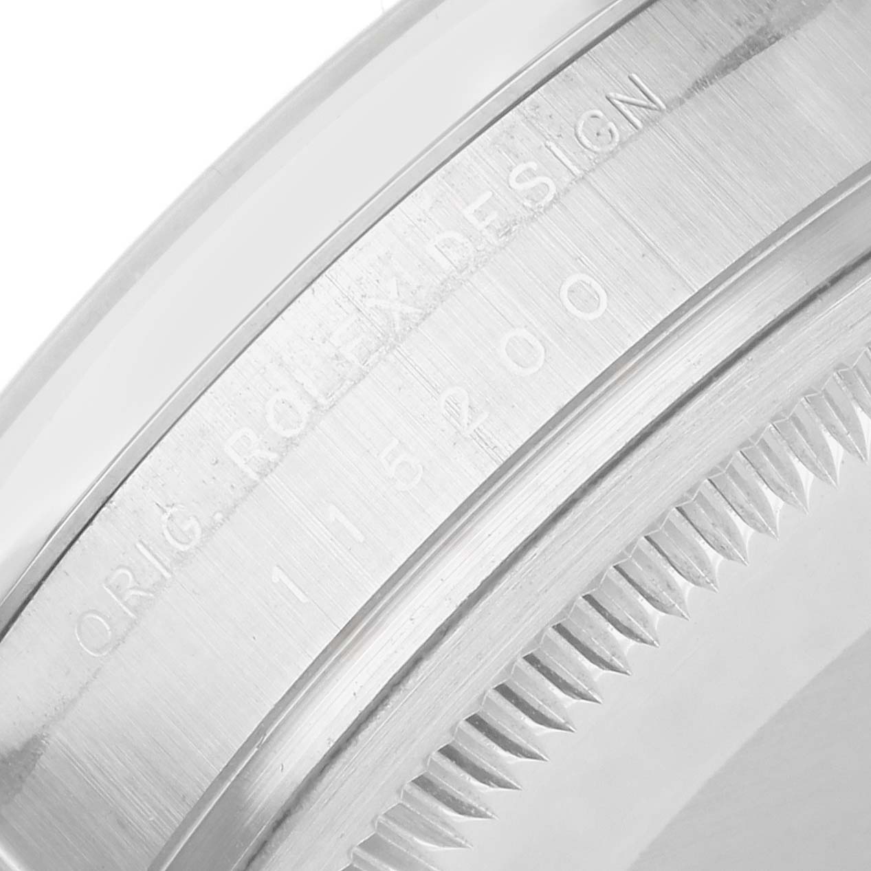 The image shows a close-up of the engraved side of a Rolex Date 115200 Men's Stainless Steel Pink Dial model watch, focusing on the bezel and the edge of the case.
