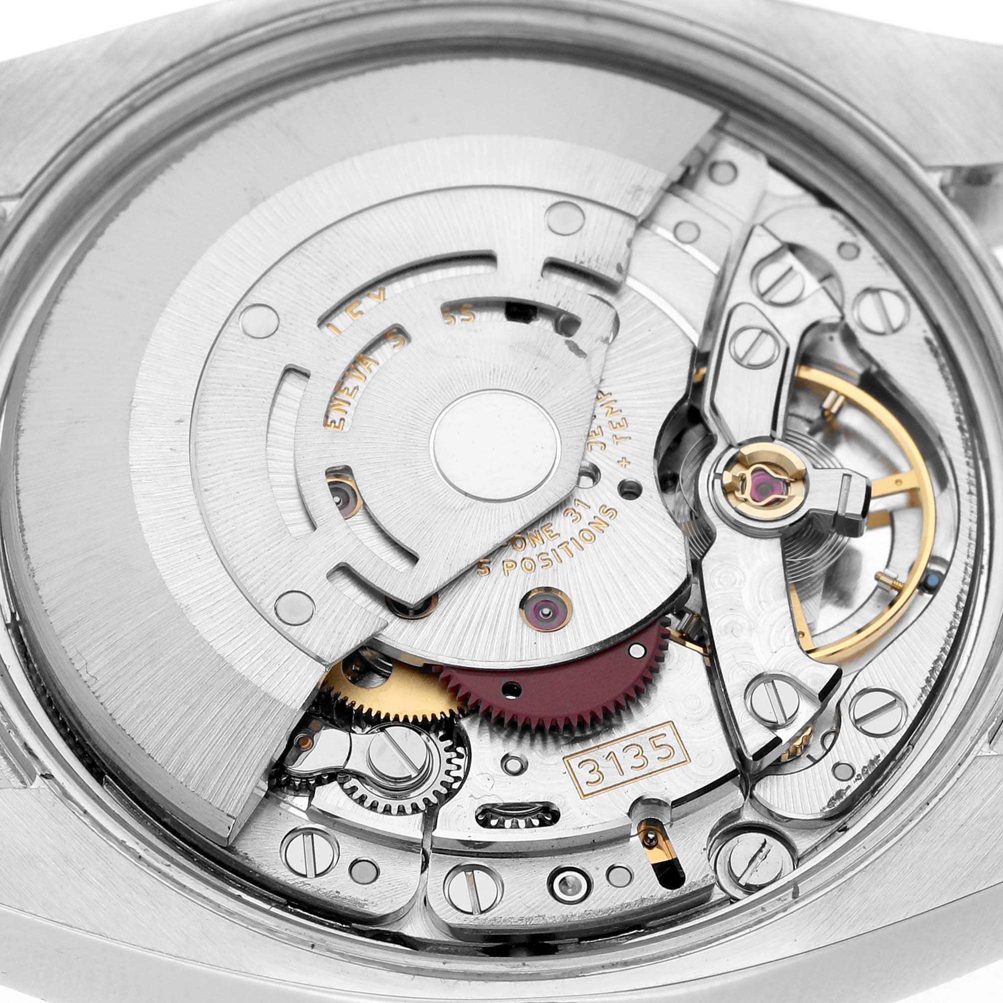 The image shows the Rolex Date 115200 Men's Stainless Steel Pink Dial model's movement from the back, highlighting intricate gears and the rotor.