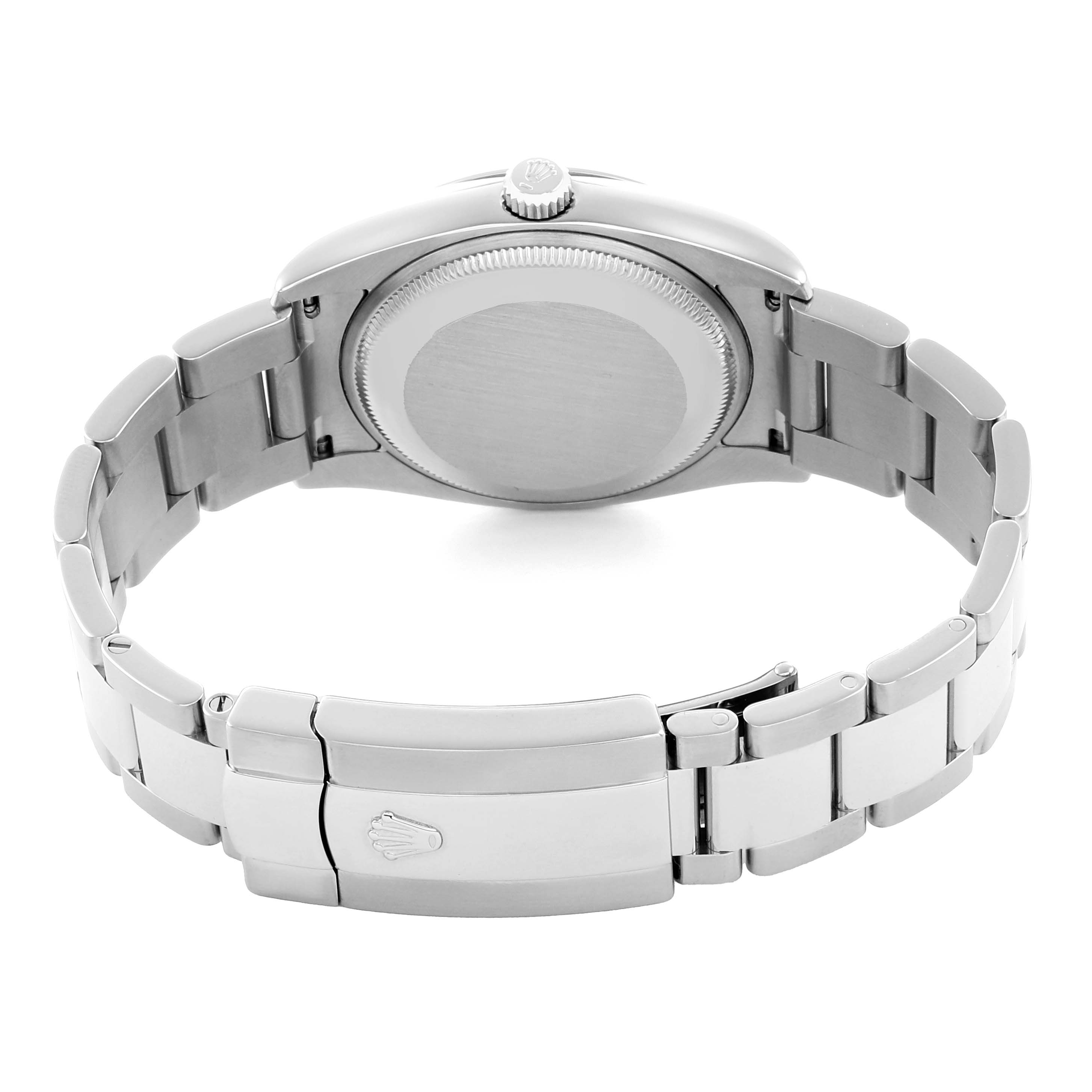 The image shows the back view of a Rolex Date 115200 Men's Stainless Steel Pink Dial model watch, highlighting the clasp, bracelet, and caseback.