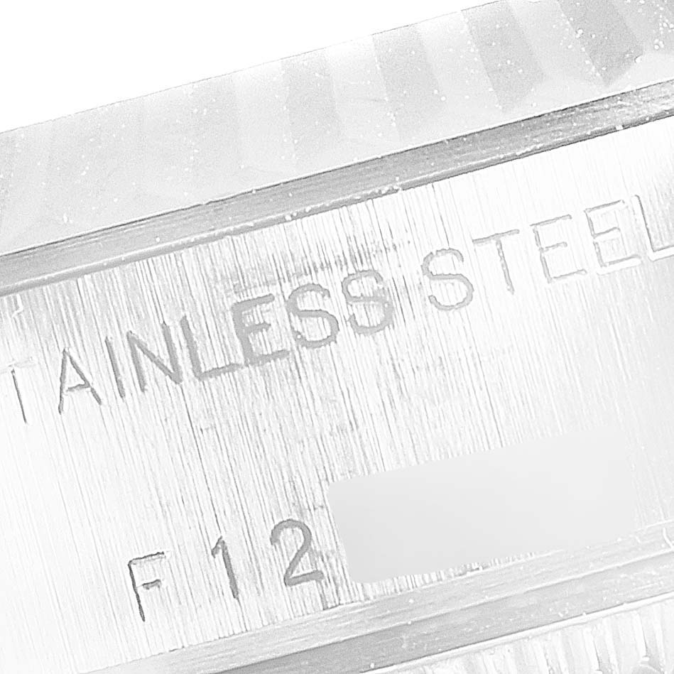 This close-up shows the engraved "STAINLESS STEEL" marking of a Rolex Datejust 79174 Women's Stainless Steel White Dial 79174 Women's Stainless Steel White Dial watch.