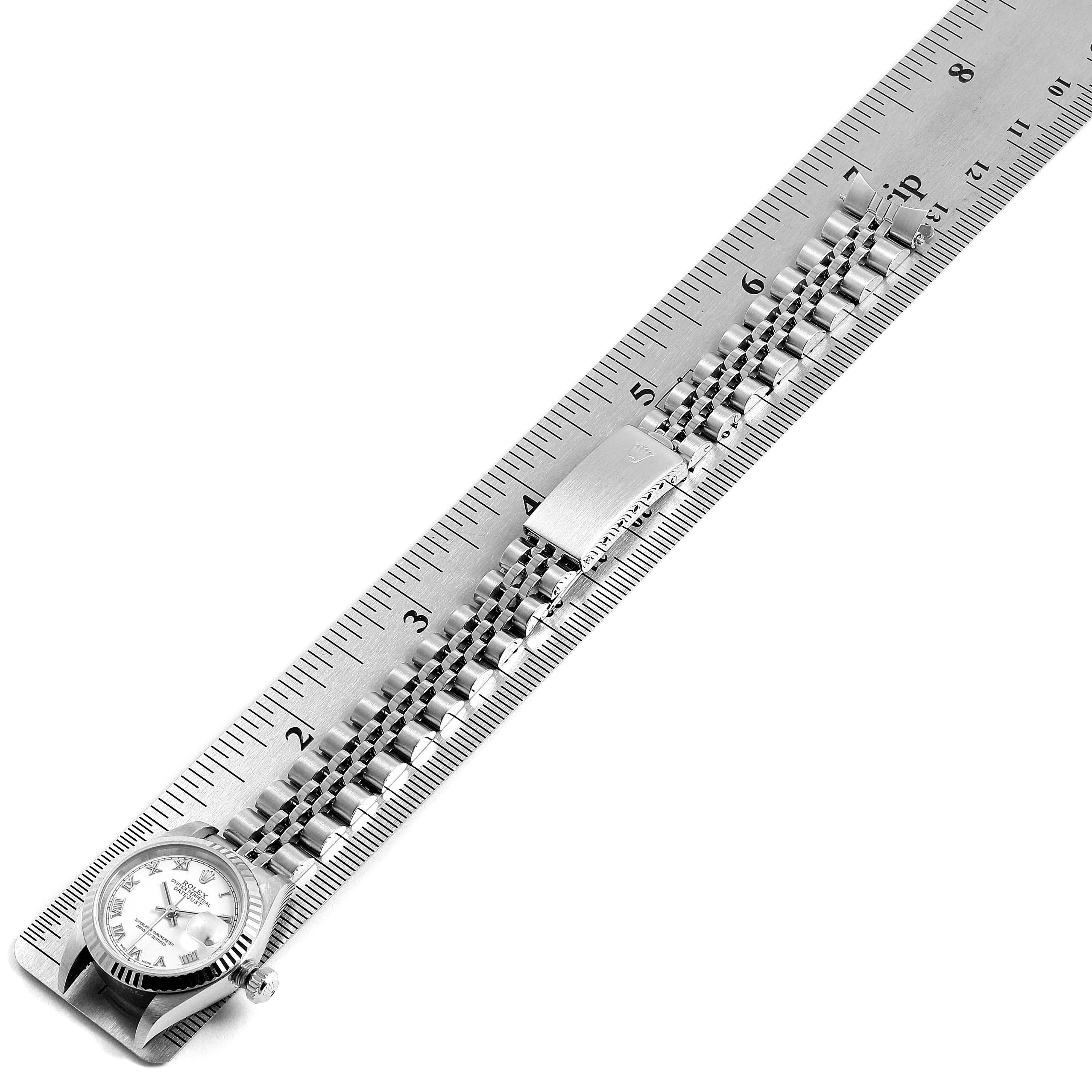 The image shows a Rolex Datejust 79174 Women's Stainless Steel White Dial 79174 Women's Stainless Steel White Dial watch and its bracelet, placed alongside a ruler to measure it.