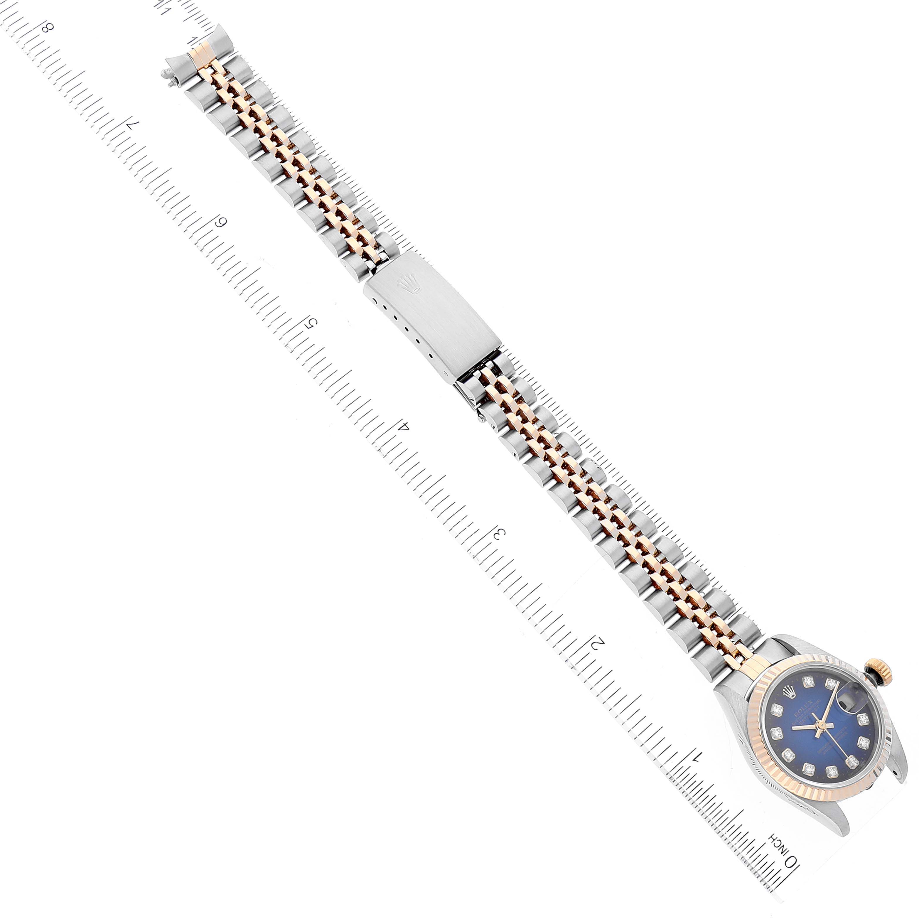 This image shows the Rolex Datejust 69173 Women's Steel and Gold (two tone) Blue Dial 69173 Women's Steel and Gold (two tone) Blue Dial watch from a top-down angle, displaying its face, bracelet, and clasp next to a measuring ruler.
