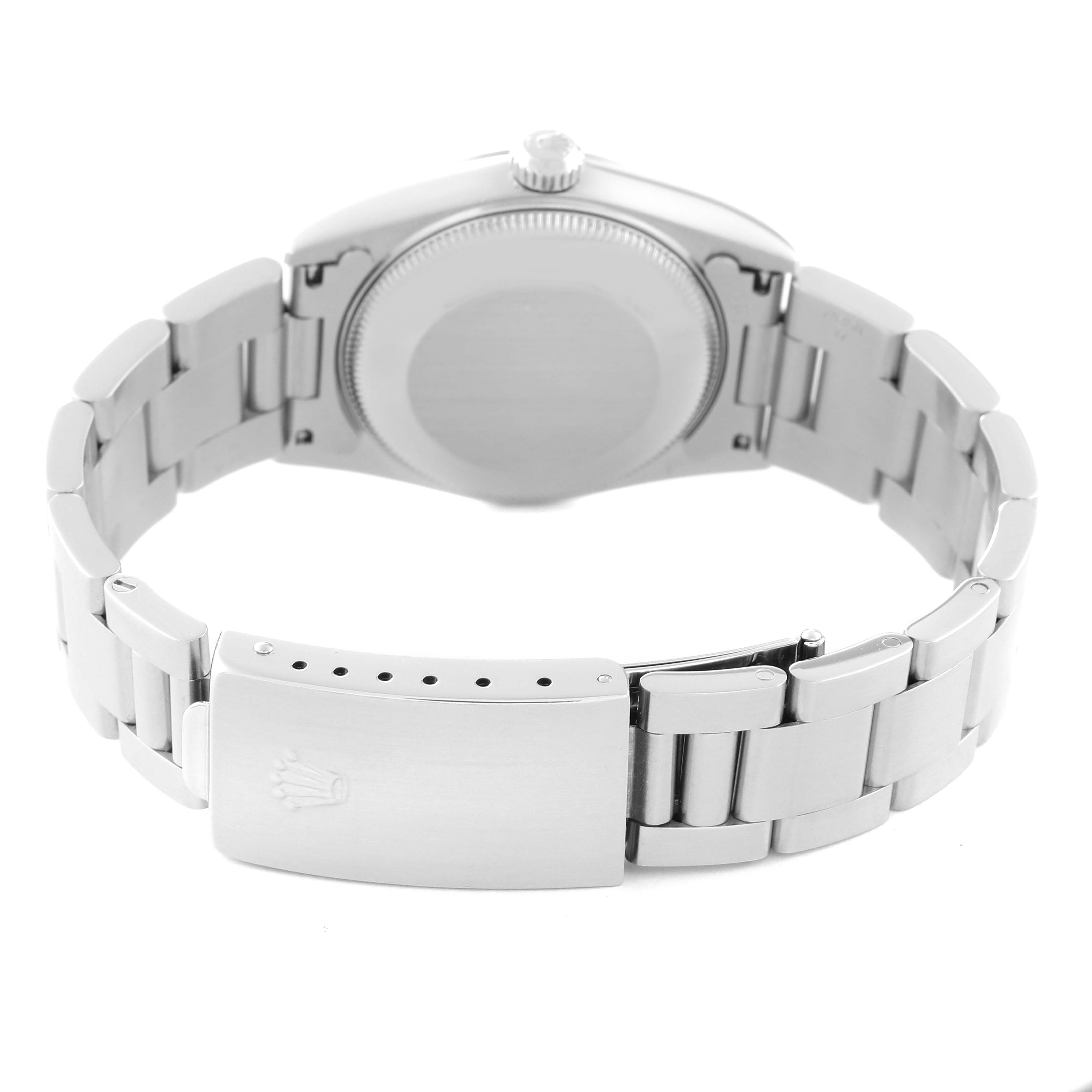 The image shows the back case and clasp of a Mid-Size Rolex watch, displaying its metal bracelet and closed lock.