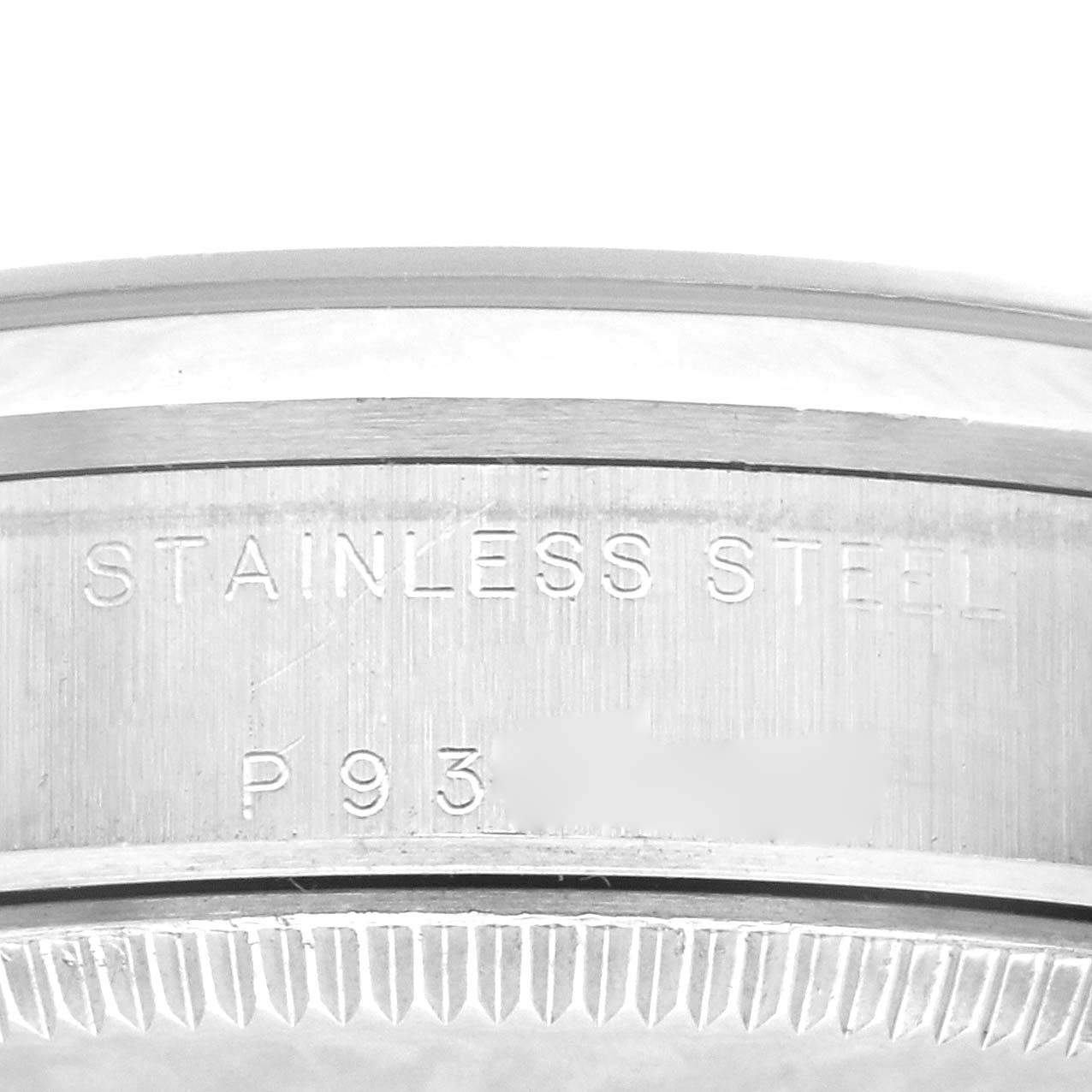This image shows a close-up view of the stainless steel case back of a Mid-Size Rolex watch, featuring part of its serial number.