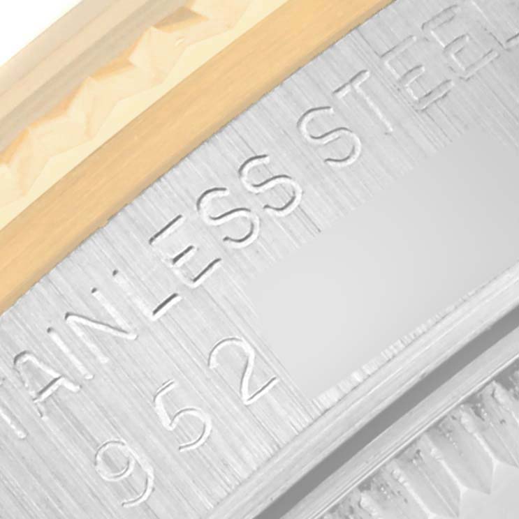 The image shows a close-up of the Mid-Size Rolex watch, highlighting the "Stainless Steel" engraving on the case.