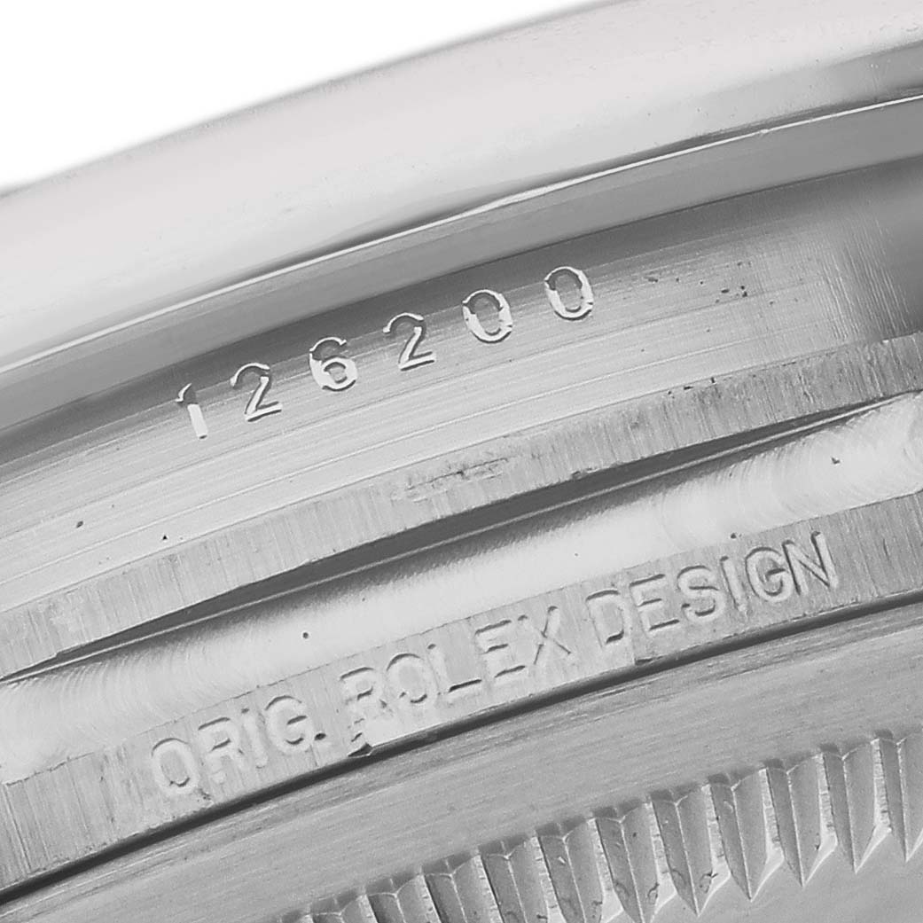 This close-up image shows the model number and "Orig. Rolex Design" engraving on the case of a Rolex Datejust 126200 Men's Stainless Steel Silver Dial 126200 Men's Stainless Steel Silver Dial watch.