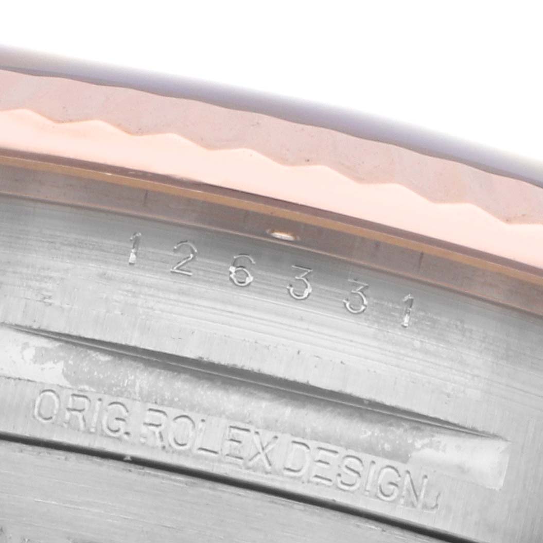The image shows a close-up of the inner bezel and case details of a Rolex Datejust 41 126331 Men
s Steel and Gold (two tone) Brown Dial, revealing engraved design and model number.