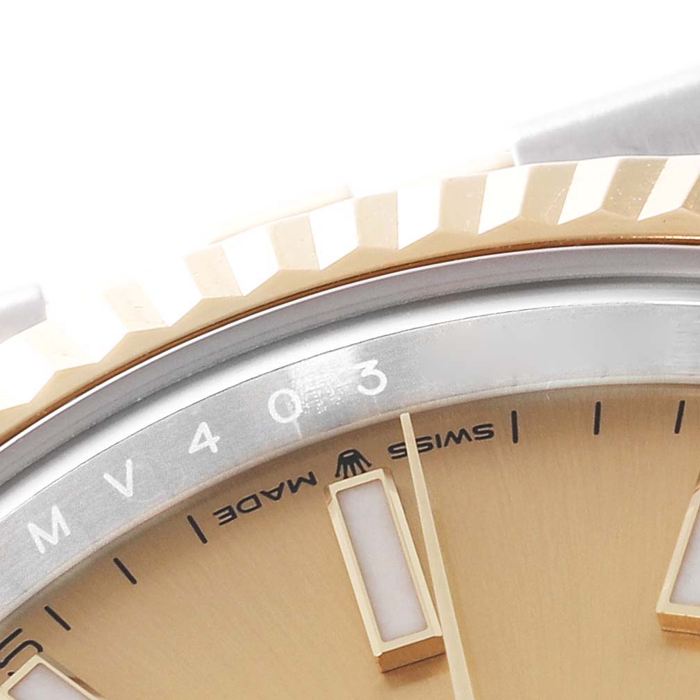 This image shows a close-up of the dial and fluted bezel of a Rolex Datejust 41 126333 Men's Steel and Gold (two tone) Champagne Dial 126333 Men's Steel and Gold (two tone) Champagne Dial watch.