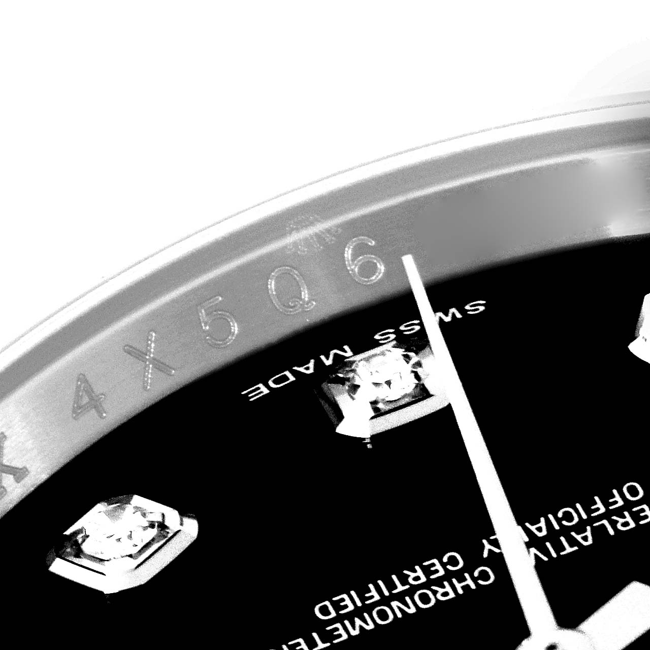 This close-up image of a Rolex Datejust 116244 Men
s Stainless Steel Black Dial 116244 Men
s Stainless Steel Black Dial watch shows the bezel, serial number, dial, and diamond hour markers, angled upward.