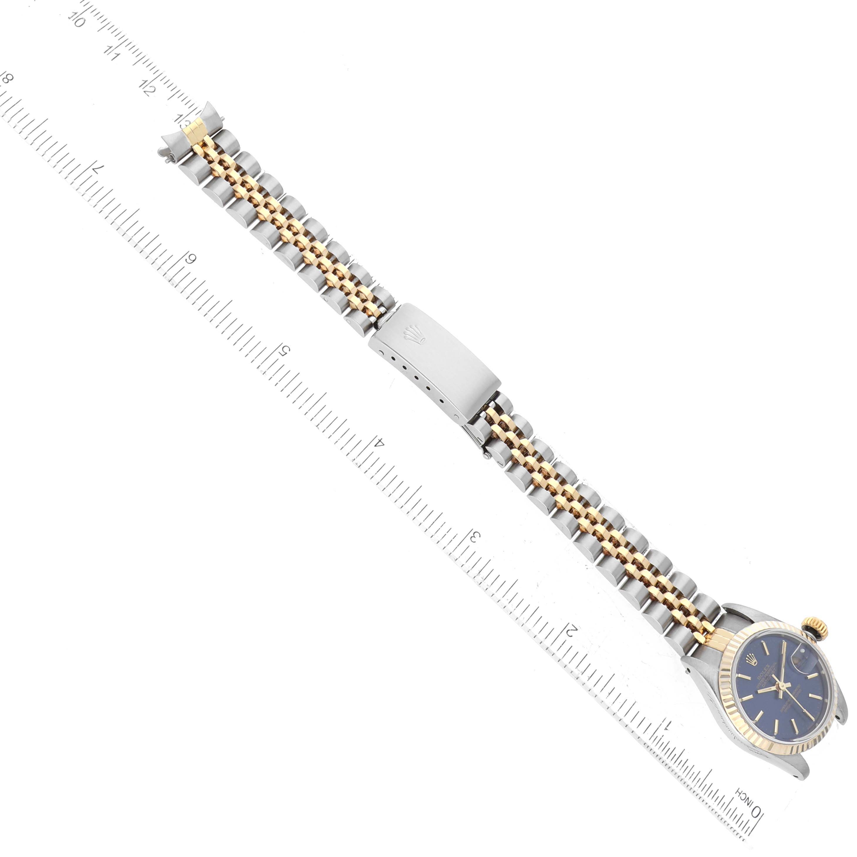 The image shows a Rolex Datejust 69173 Women's Steel and Gold (two tone) Blue Dial 69173 Women's Steel and Gold (two tone) Blue Dial watch from a top-down angle, highlighting the bracelet and face next to a ruler for scale.