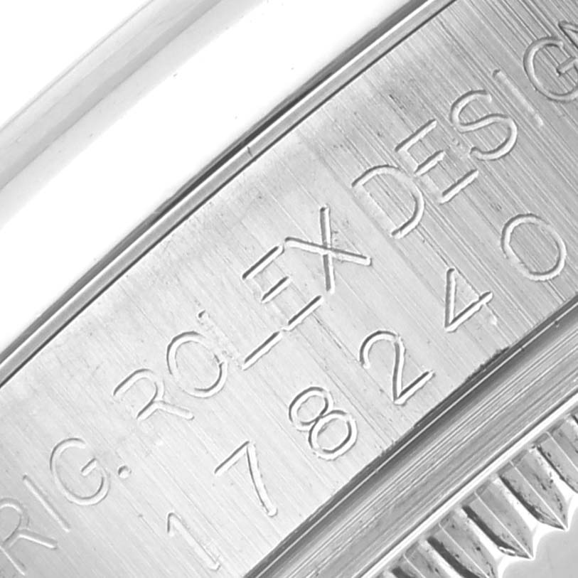 This close-up image showcases the engraved inner bezel and fluted edge of the casing of a Mid-Size Rolex watch.