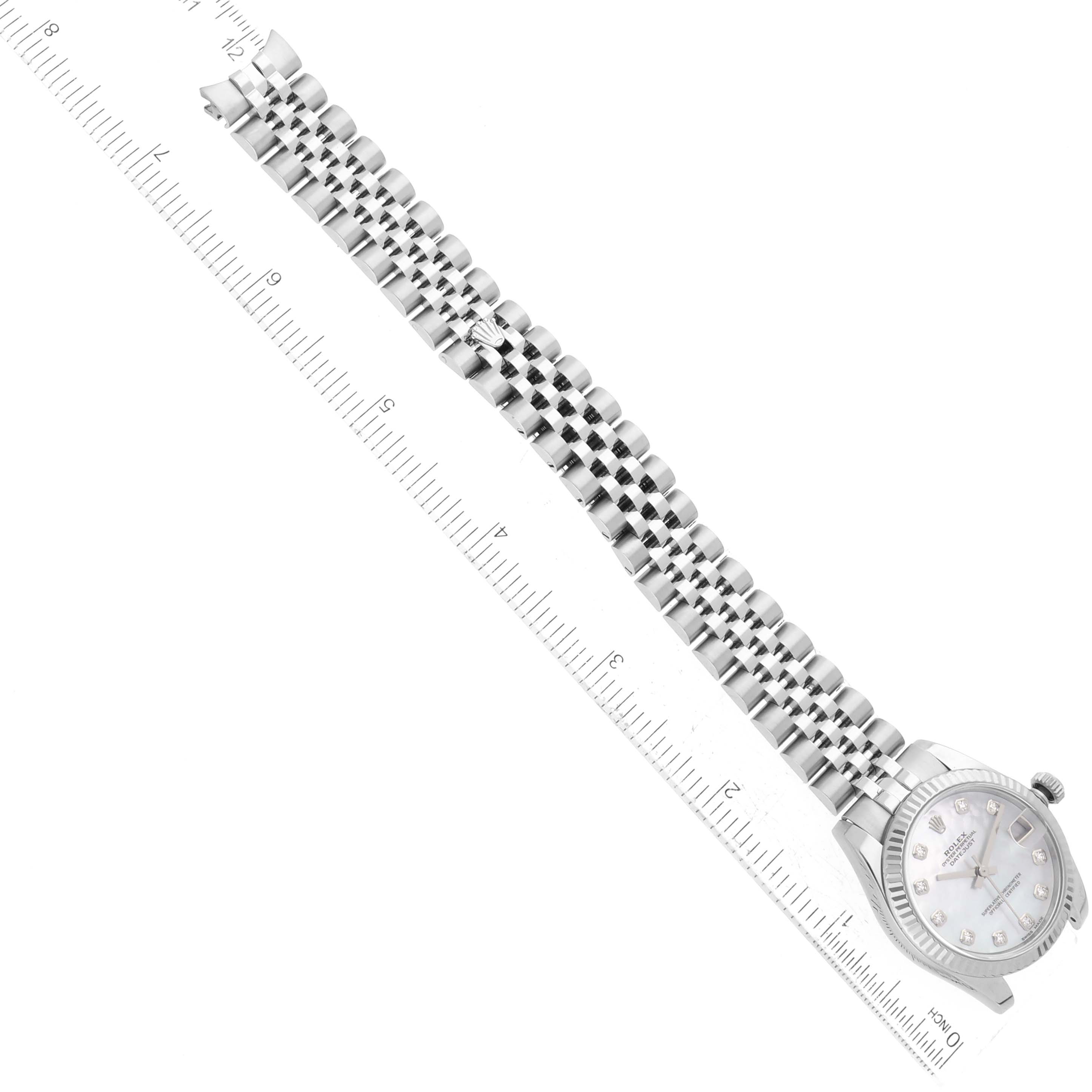 The image shows a Rolex Mid-Size 178274 Women's Stainless Steel Mother of Pearl Dial 178274 Women's Stainless Steel Mother of Pearl Dial watch from a top-down angle, highlighting the watch face, bracelet, and a ruler for scale.