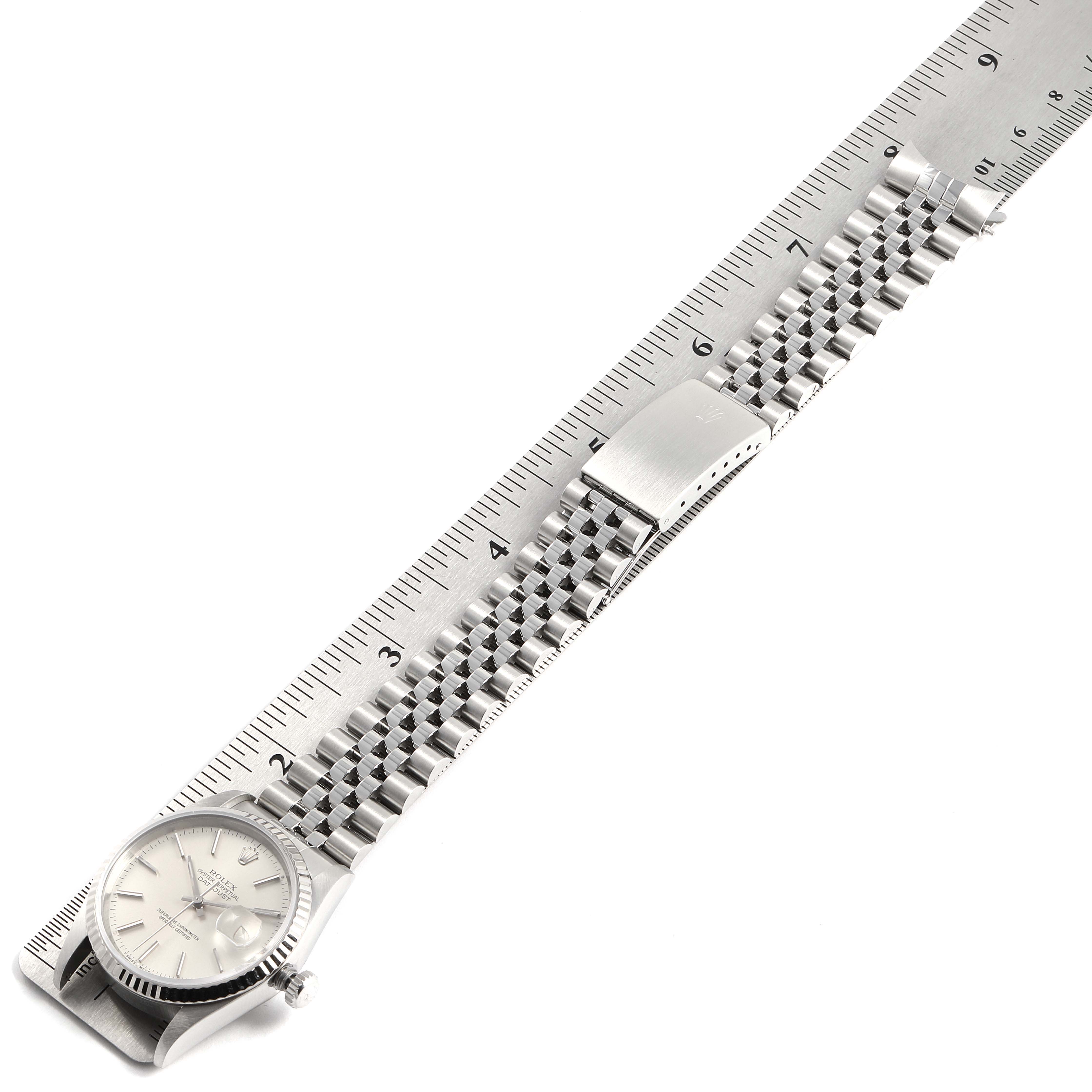 The image shows the Rolex Datejust 16234 Men's Stainless Steel Silver Dial 16234 Men's Stainless Steel Silver Dial watch face and bracelet laying flat, aligned with a ruler for measurement.