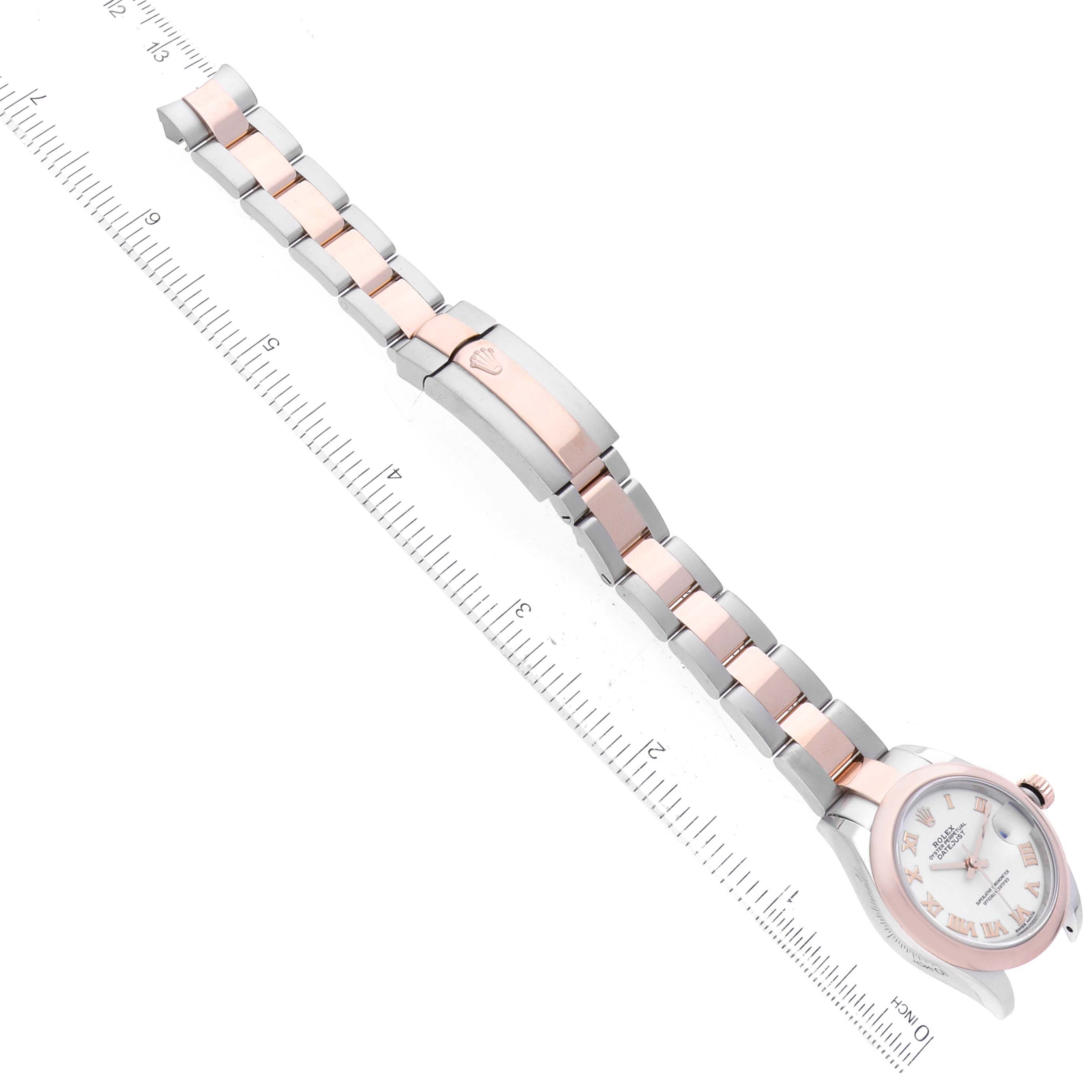 The datejust model by Rolex is shown at a top-down angle, displaying its full band, clasp, and watch face with prominent markers.