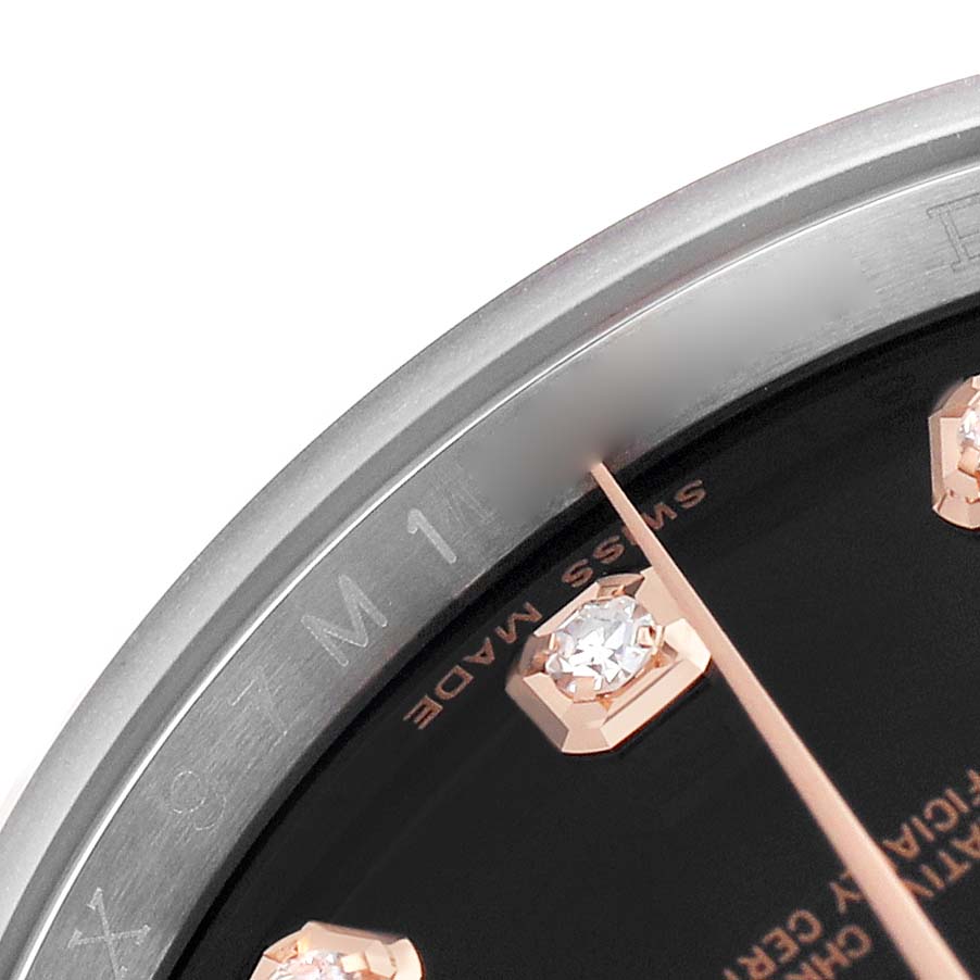 The image shows a close-up of the Rolex Datejust 116231 Men's Steel and Gold (two tone) Black Dial's dial and bezel at an angle, highlighting the diamond markers and part of the watch hands.